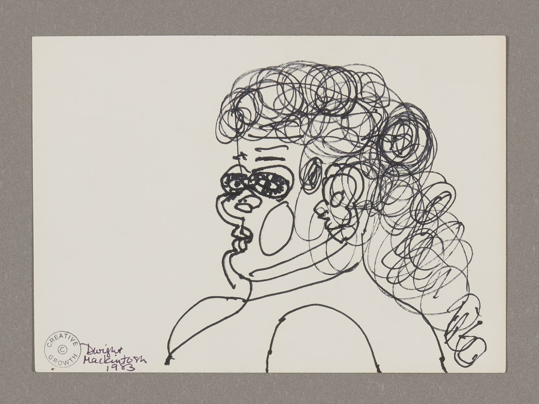 Ink drawing of figure with curly hair and expressive facial features on white paper