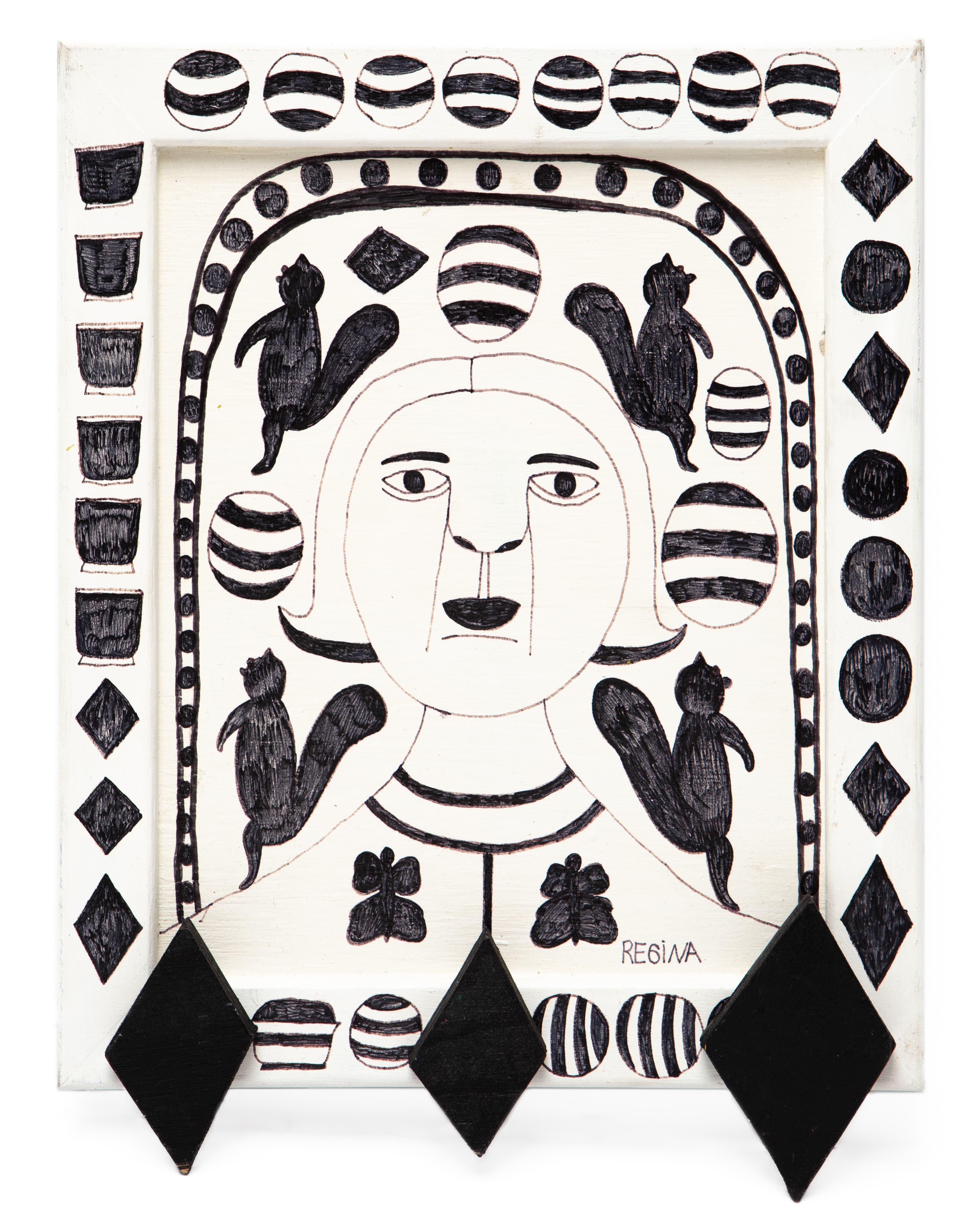 Ink on wood drawing featuring a central face surrounded by black birds and geometric patterns in black and white