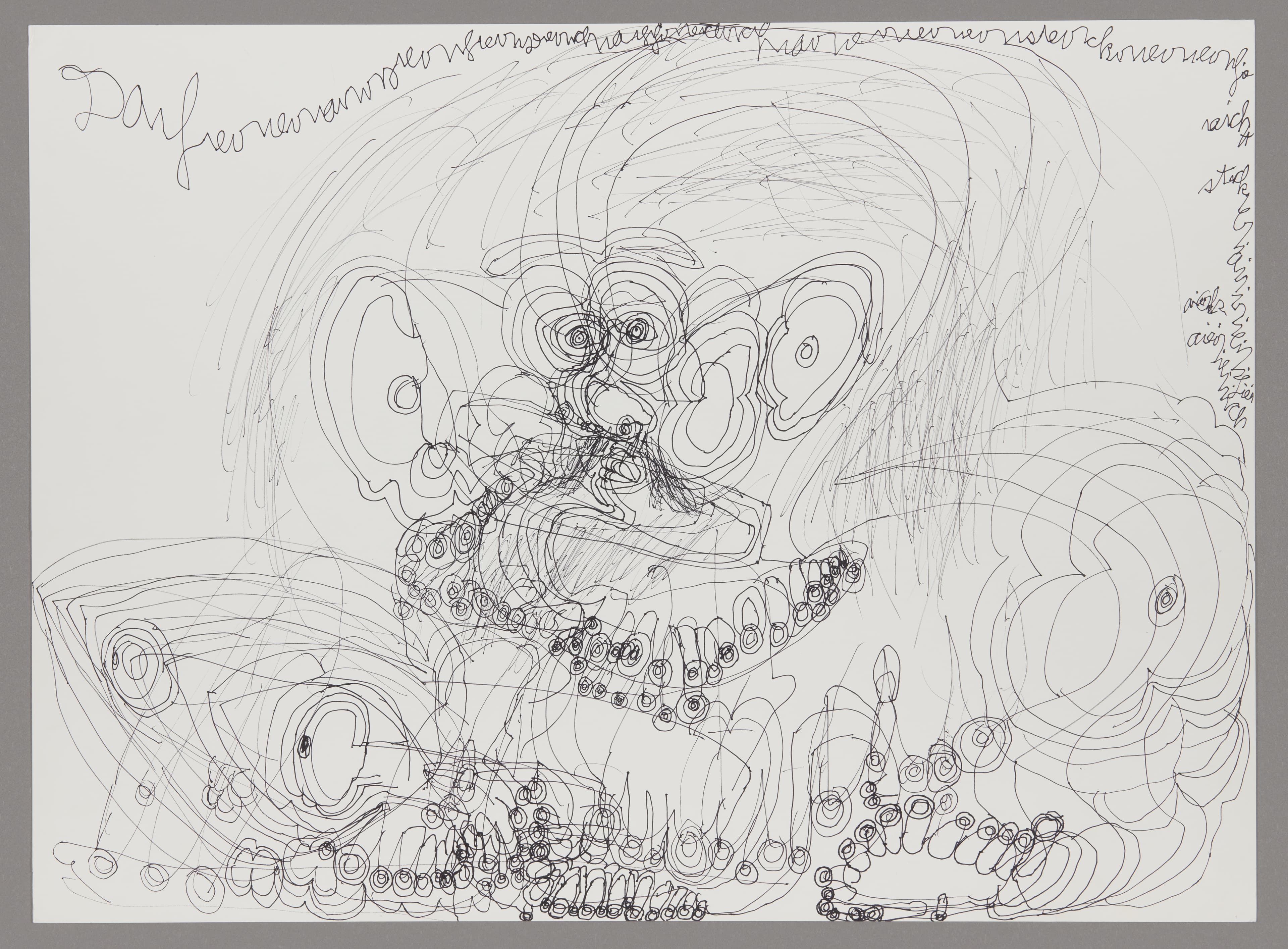 Ink drawing on paper with swirling lines forming abstract faces and circular patterns with handwritten text at top