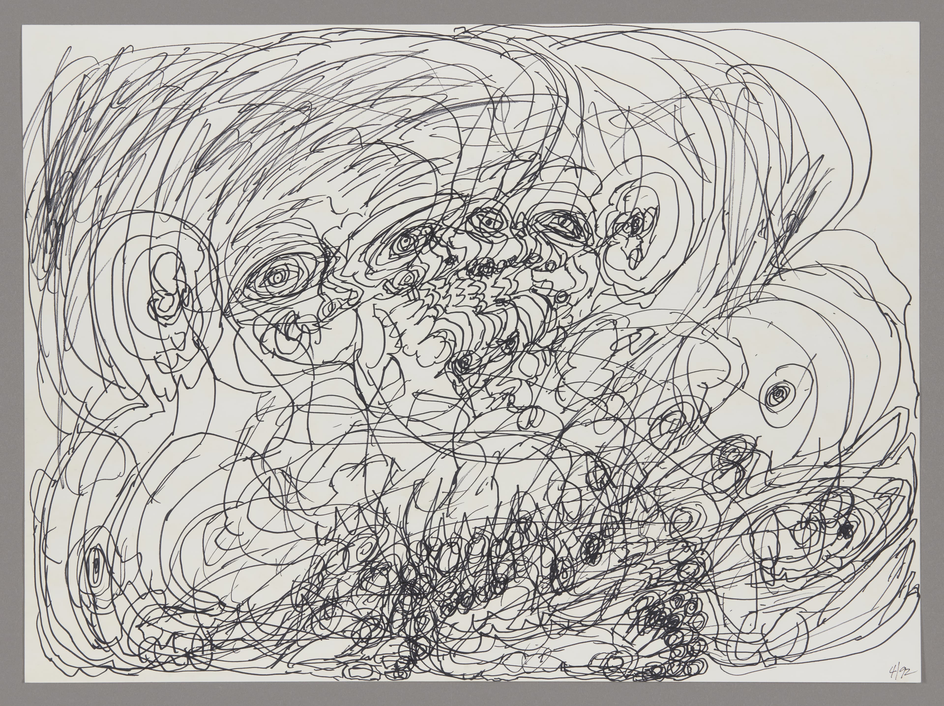 Drawing in black ink on paper showing swirling lines forming multiple faces and eyes in an energetic composition