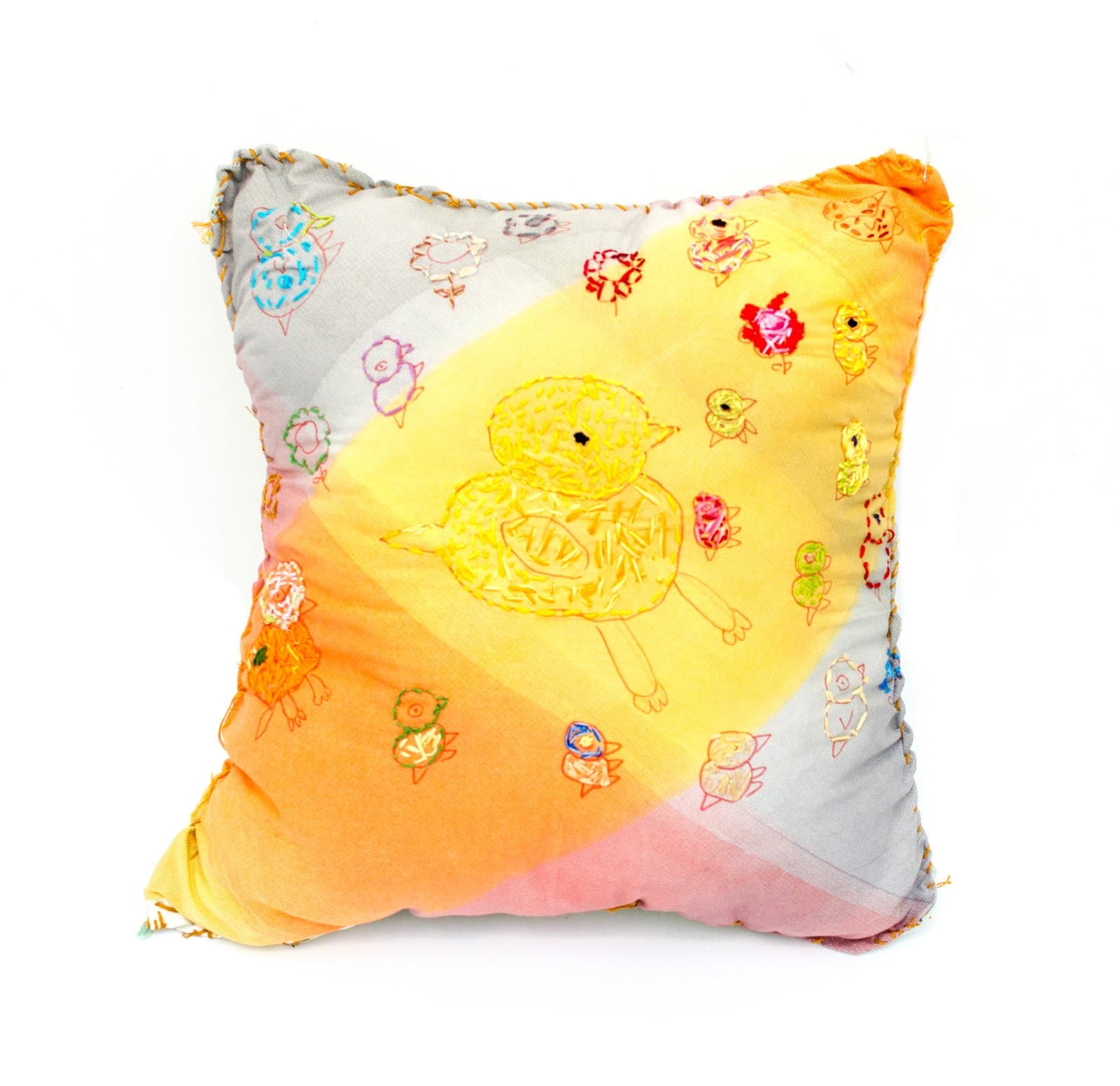 Embroidered fabric pillow with a large yellow chick at center surrounded by many small colorful chicks on orange, pink, and gray fabric.
