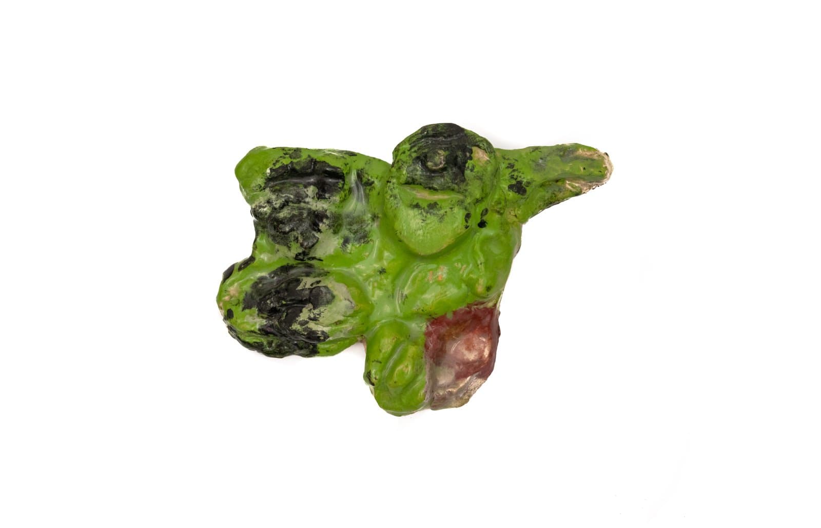 Small ceramic sculpture with lumpy, organic form glazed in bright green with black and dark red accents.