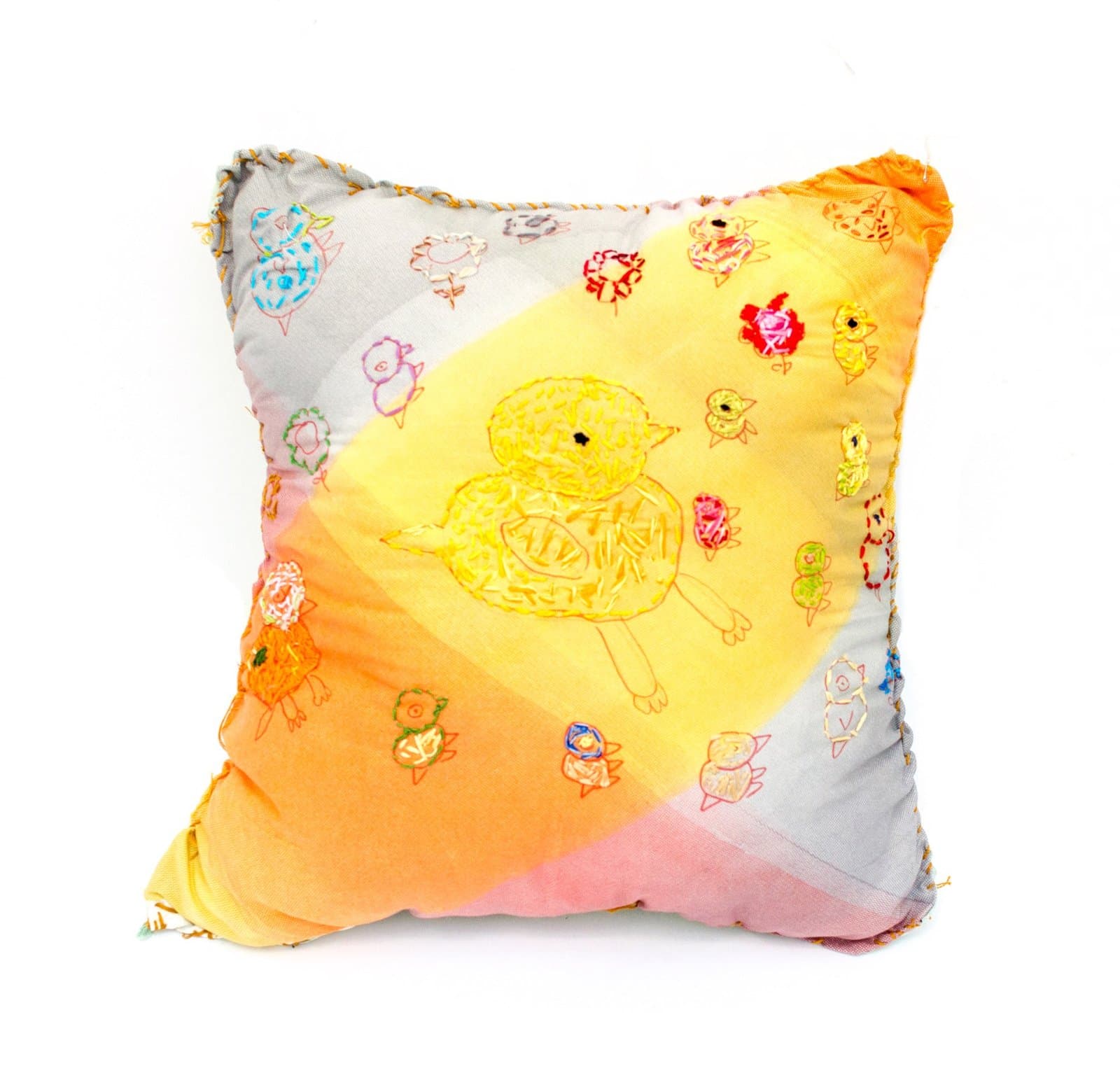 Mixed media pillow with watercolor washes in yellow, orange, and pink, decorated with small embroidered figures