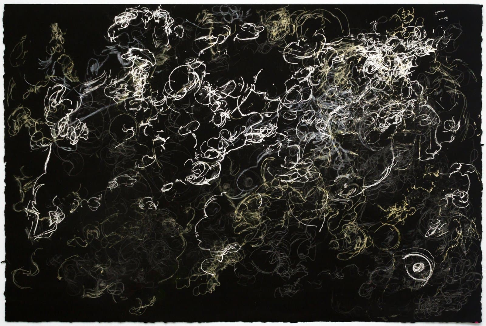 Abstract ink drawing on black paper with dense white and gold swirling, looping lines radiating across the surface.