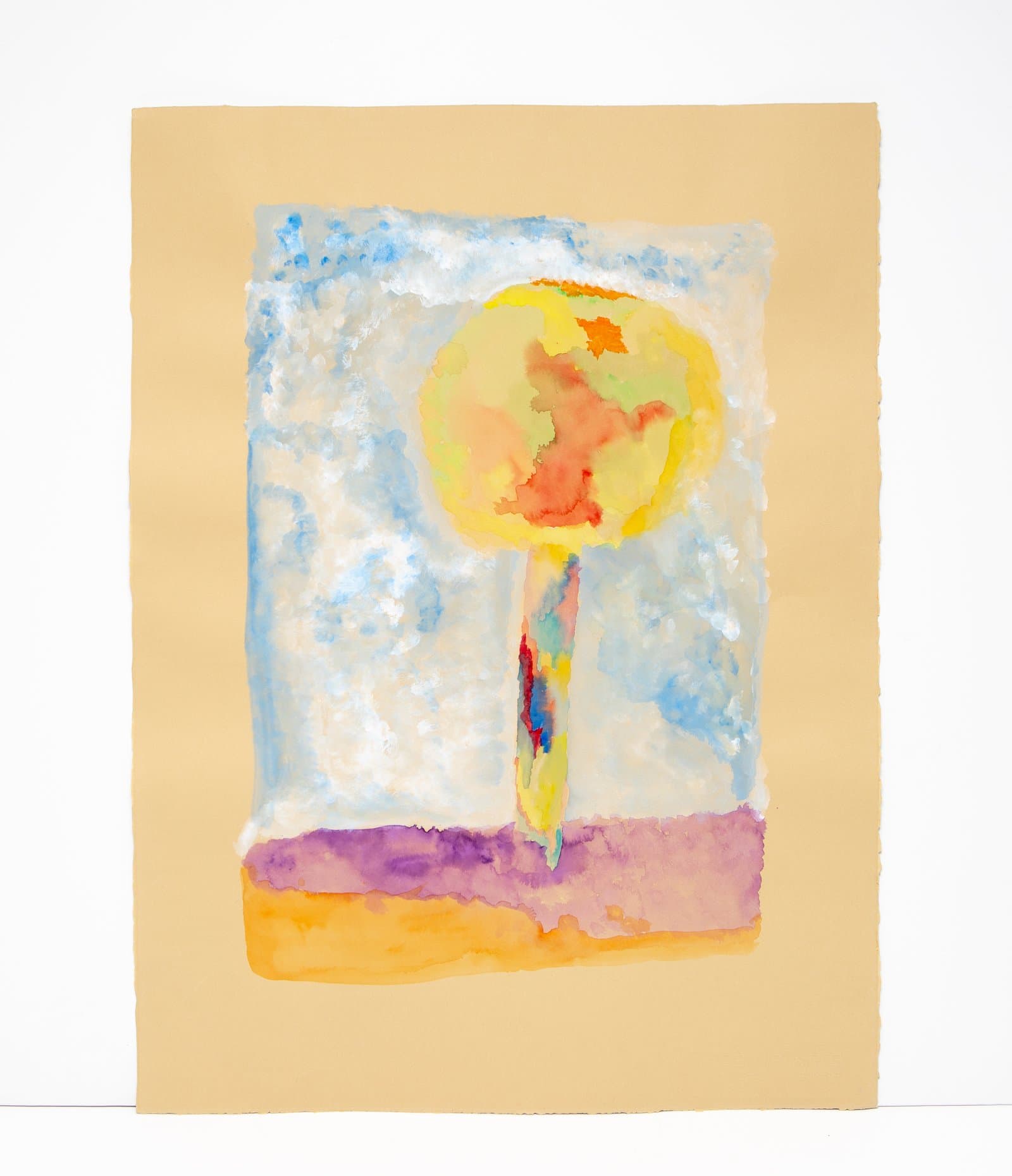 Watercolor painting of a lollipop-shaped tree with a round yellow canopy on a multicolored trunk against a blue sky.