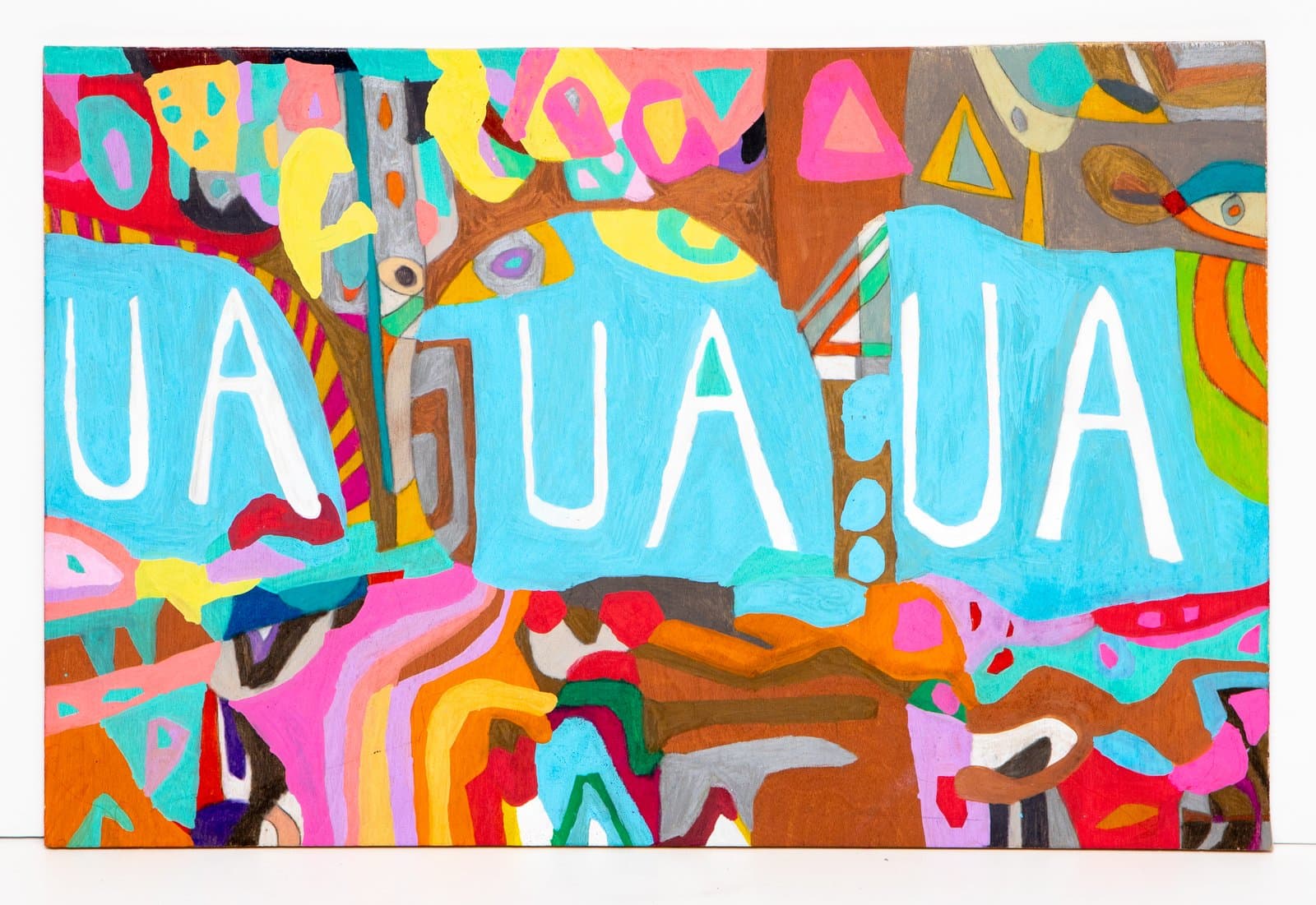 Mixed media painting on wood with bold abstract shapes in bright colors and white text reading 'UA UA UA' on a turquoise band.