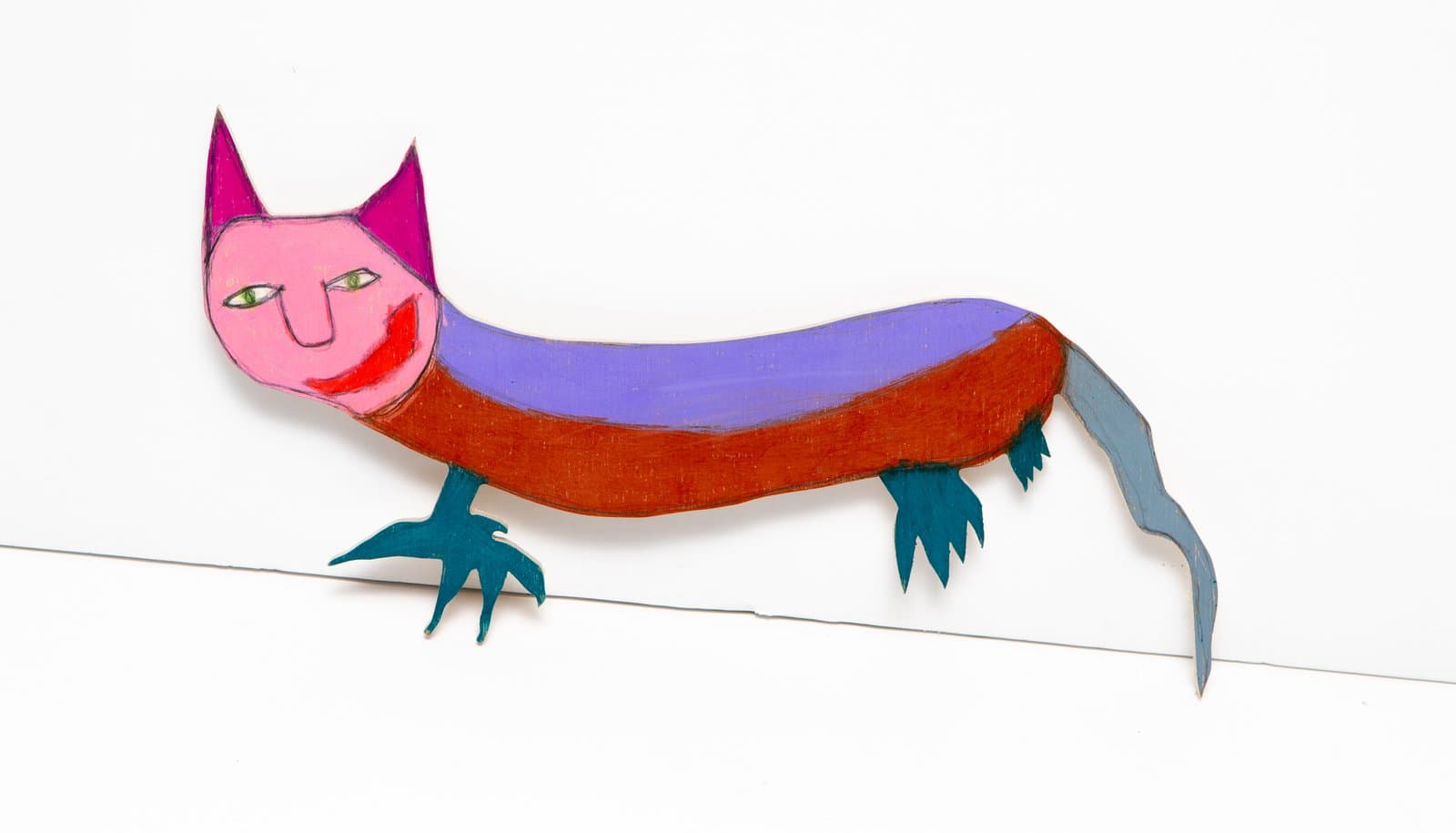 Painted wood cutout of an elongated cat-like creature with a pink face, rust-brown body, purple stripe, and teal clawed feet.