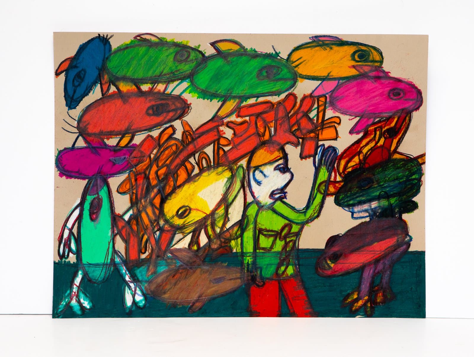 Colorful drawing in Prismastix on kraft paper depicting a human figure surrounded by large fantastical frog-like creatures.