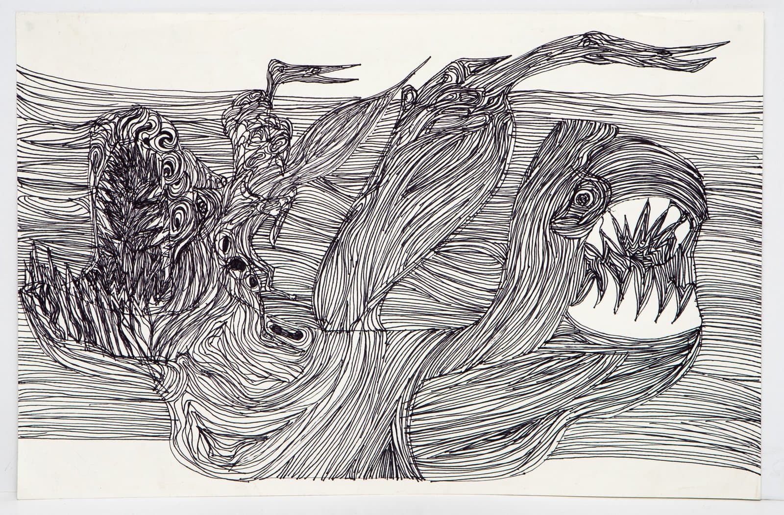 Black ink pen drawing on white paper depicting swirling organic forms and a creature with an open fanged mouth.