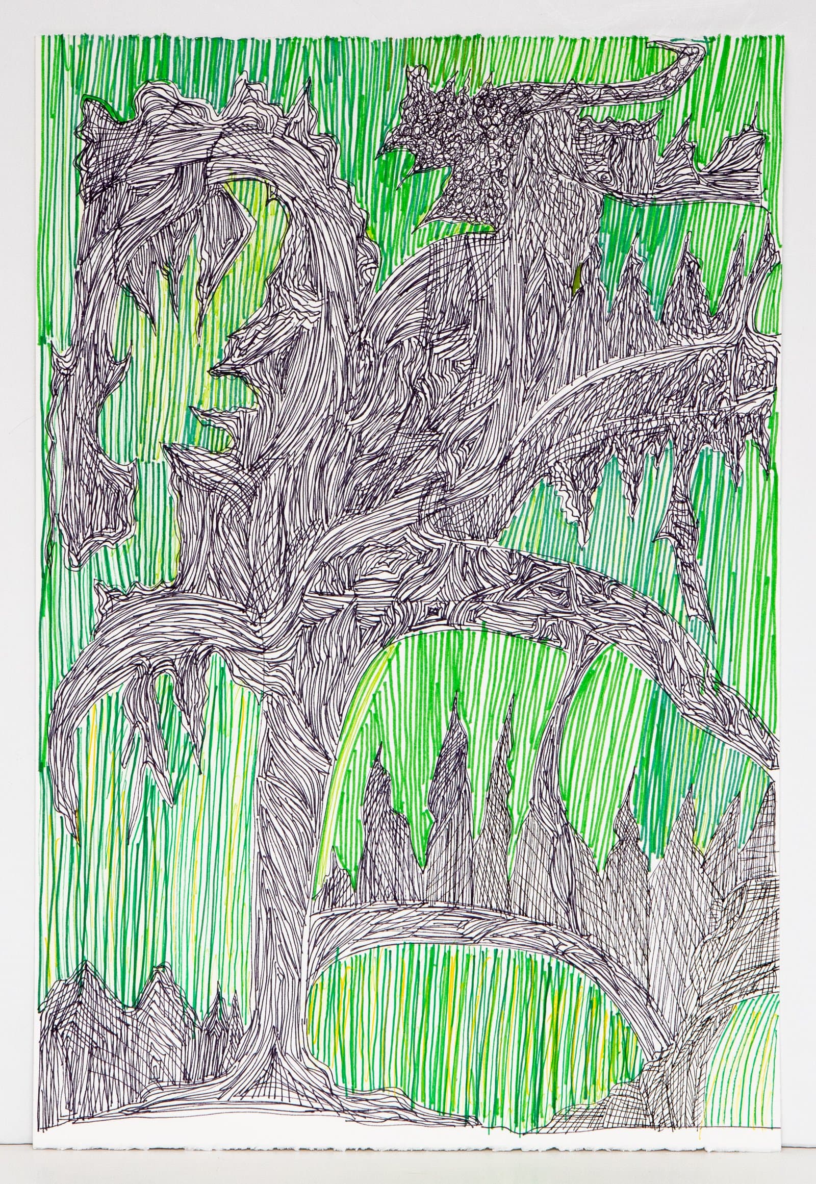 Pen drawing on paper with dense black ink forms resembling gnarled trees against a green marker-striped background.