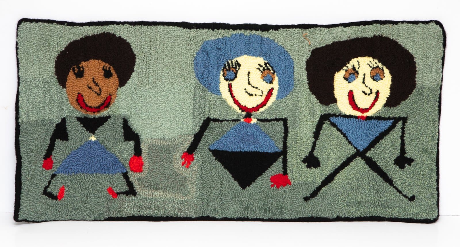 Hooked rug depicting three stylized figures with dark afro hairstyles on a muted green background.