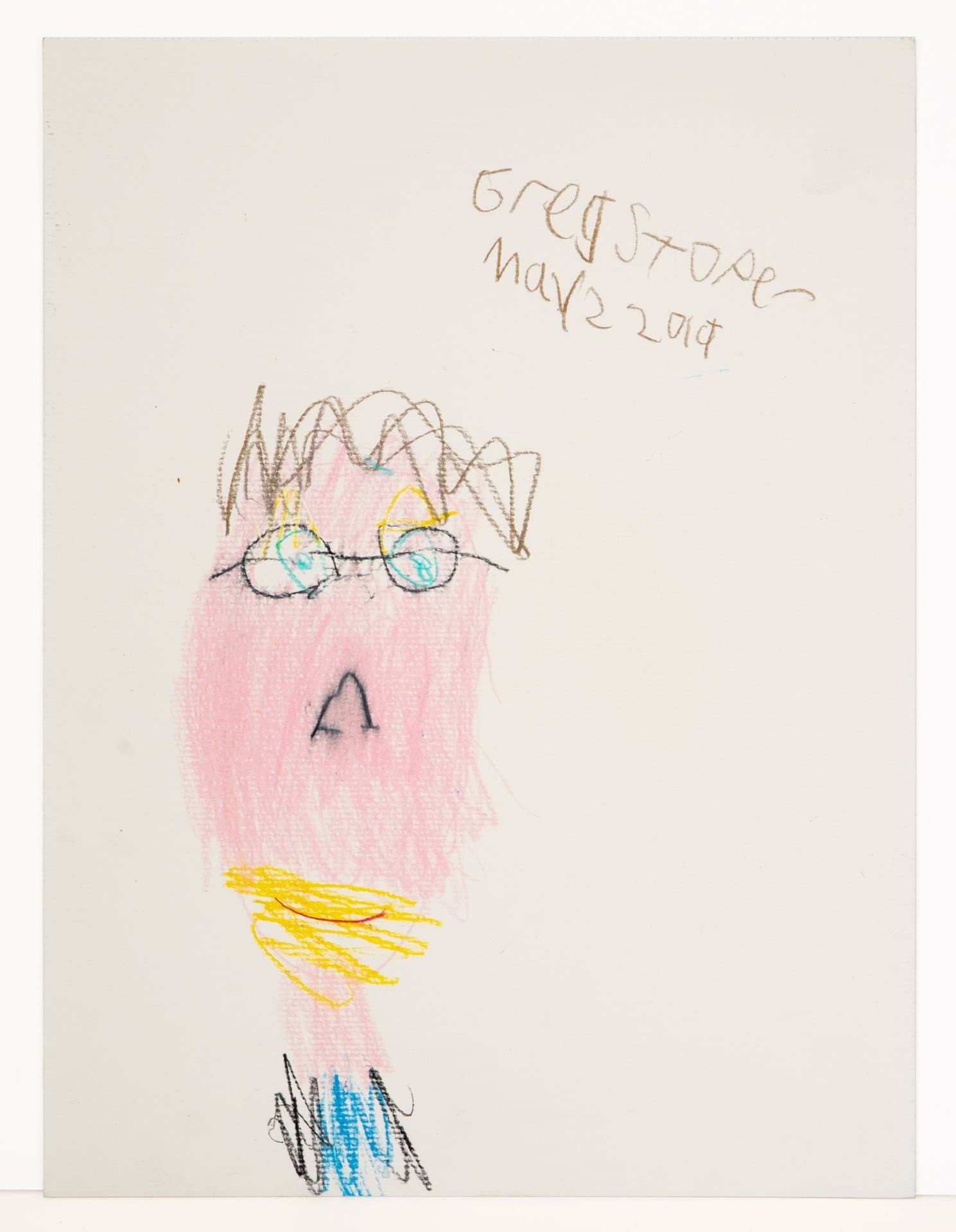 Children's drawing showing a figure with glasses and brown hair, rendered in colored pencil on white paper
