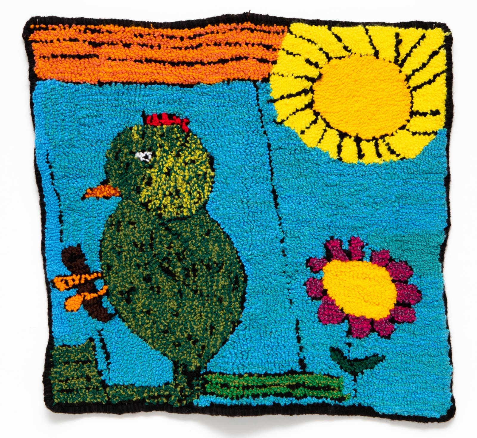 Hooked rug depicting a green chicken, yellow sun, and pink flower on a bright turquoise background with orange striped border.