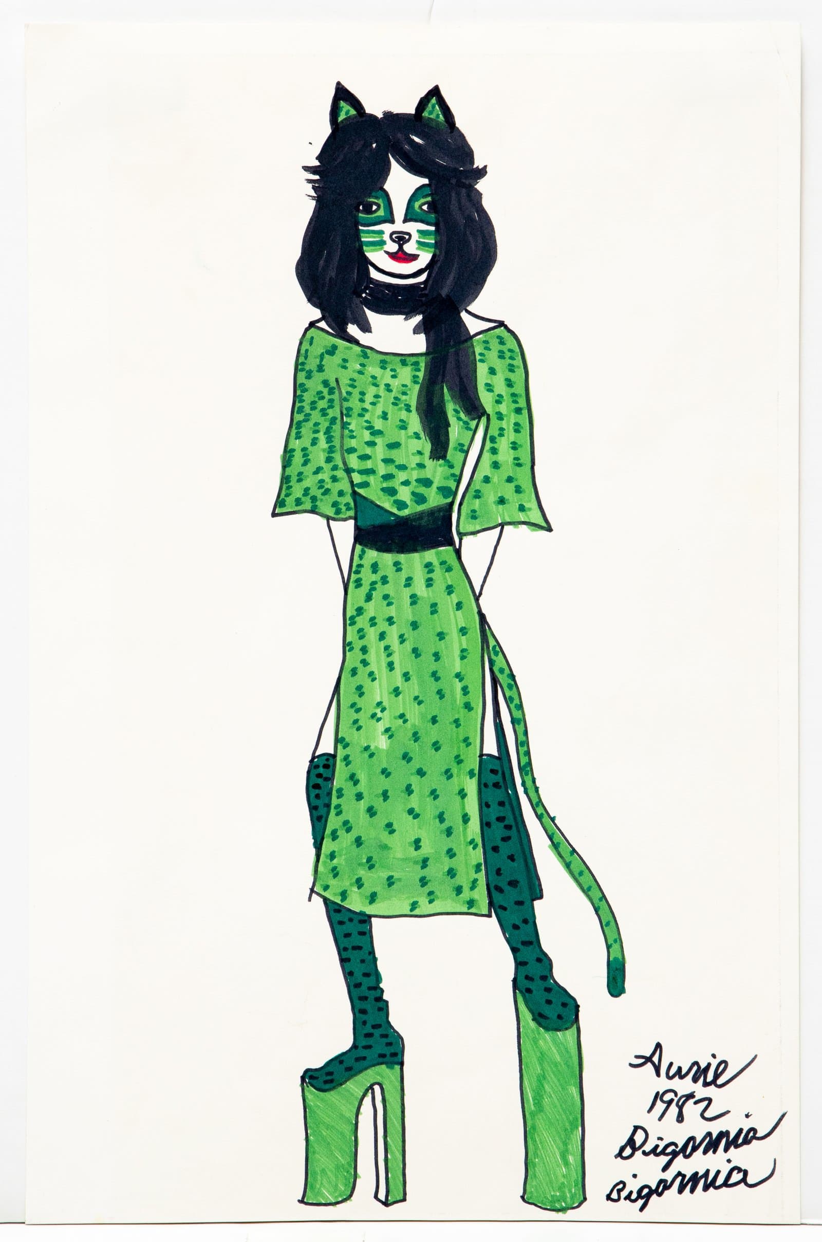 Marker drawing of a standing cat-human figure in a green spotted dress, tall platform boots, and cat ears, signed "Aurie 1982."