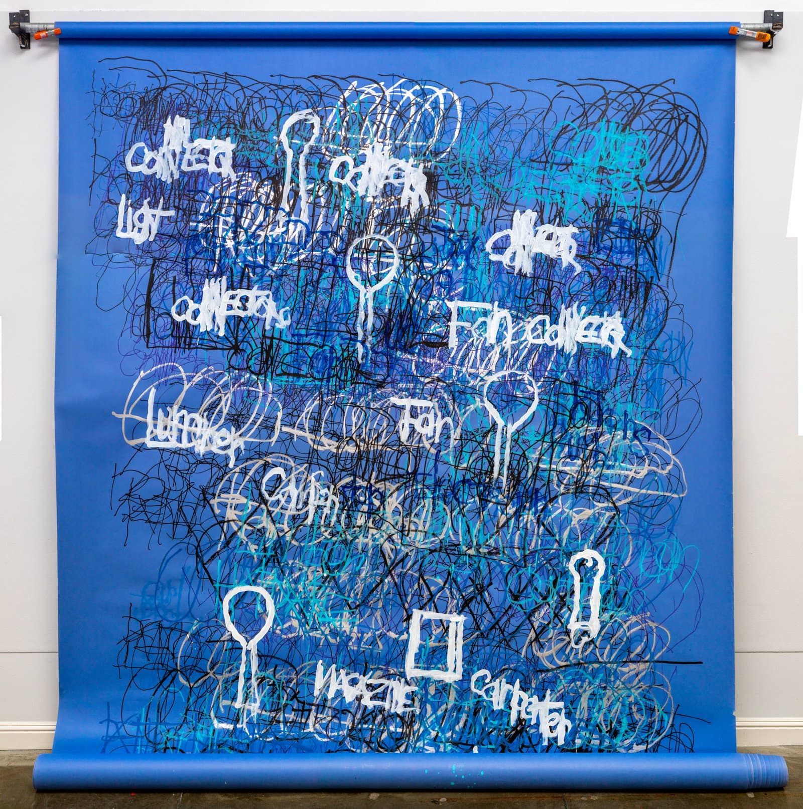 Large-scale acrylic on blue paper scroll with dense black and white scrawled text, symbols, and looping marks.