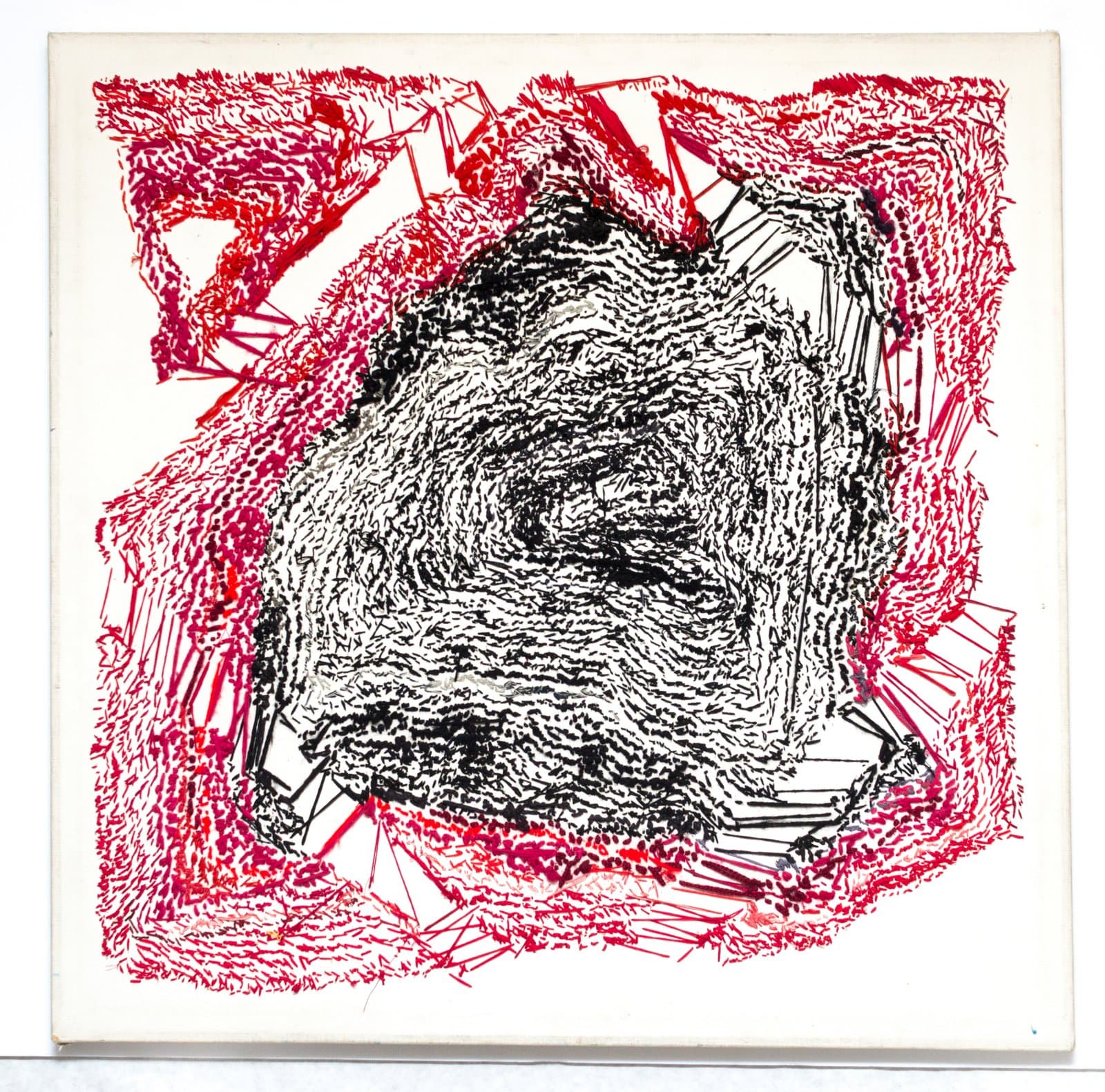 Abstract drawing with dense black swirling marks at center surrounded by red hatching and angular black lines on white paper.