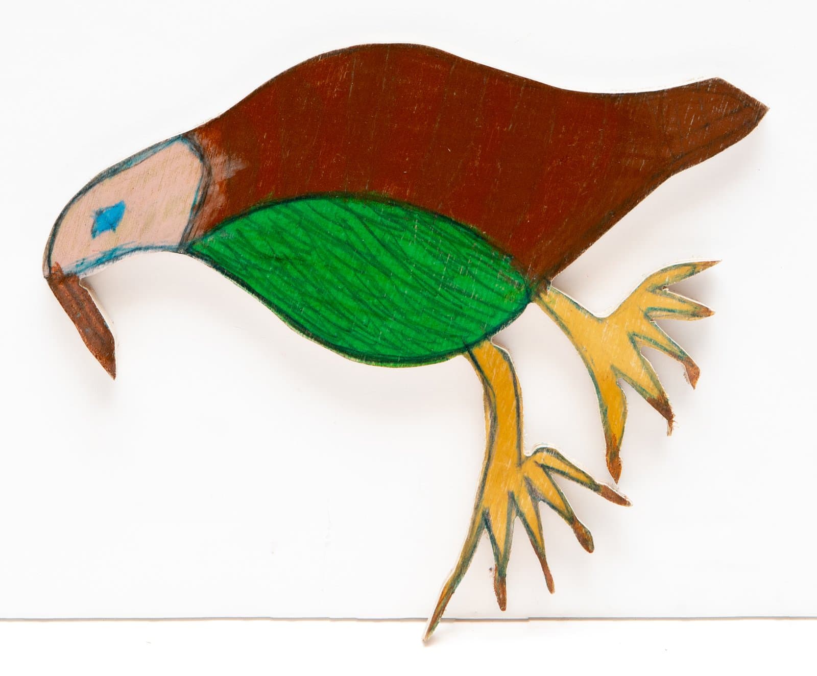 Cut-out wood sculpture of a bird with brown body, green wing, yellow claws, and a pink face with blue eye, drawn in marker.