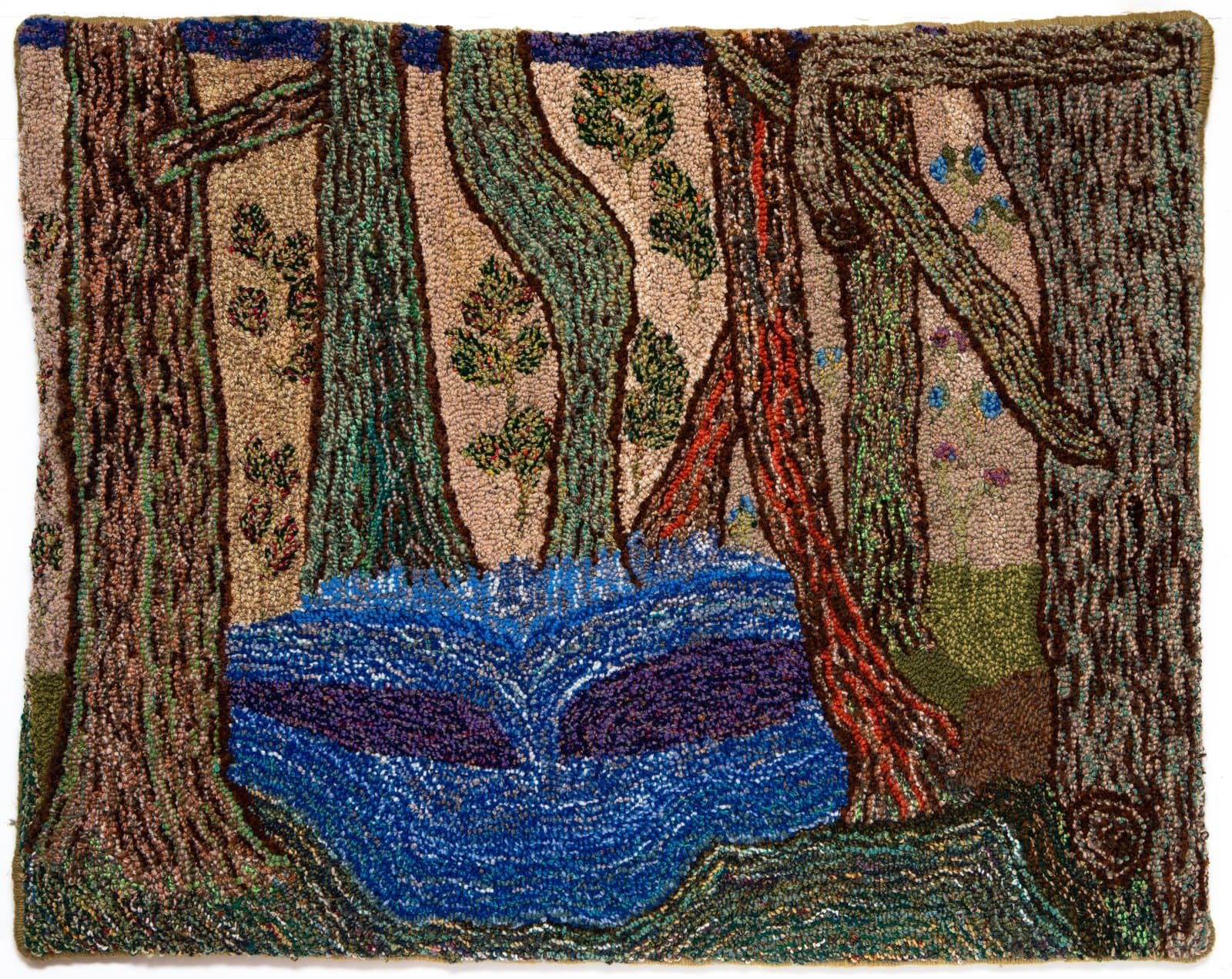 Hooked rug depicting a forest scene with tall trees surrounding a blue pond, in earth tones, greens, and blues.
