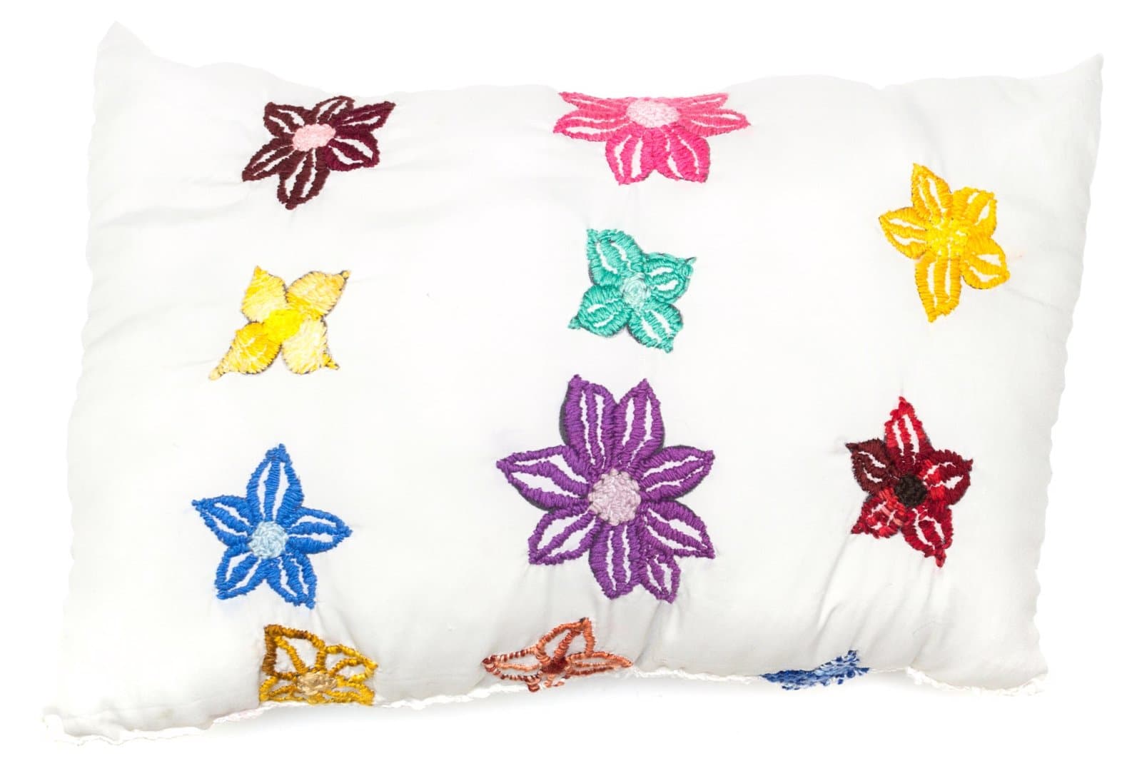Textile artwork featuring colorful embroidered flowers on white fabric pillow