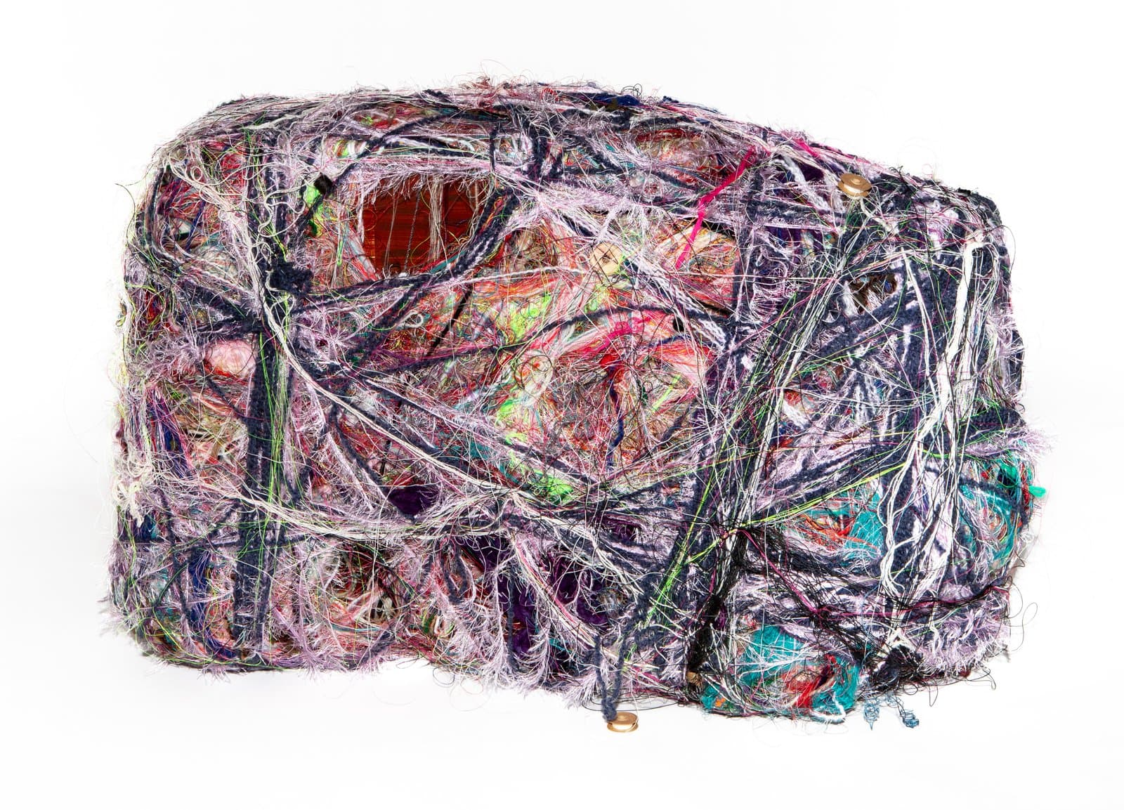 Dense wrapped textile sculpture, roughly rectangular, covered in tangled multicolored threads and fibers on white background.