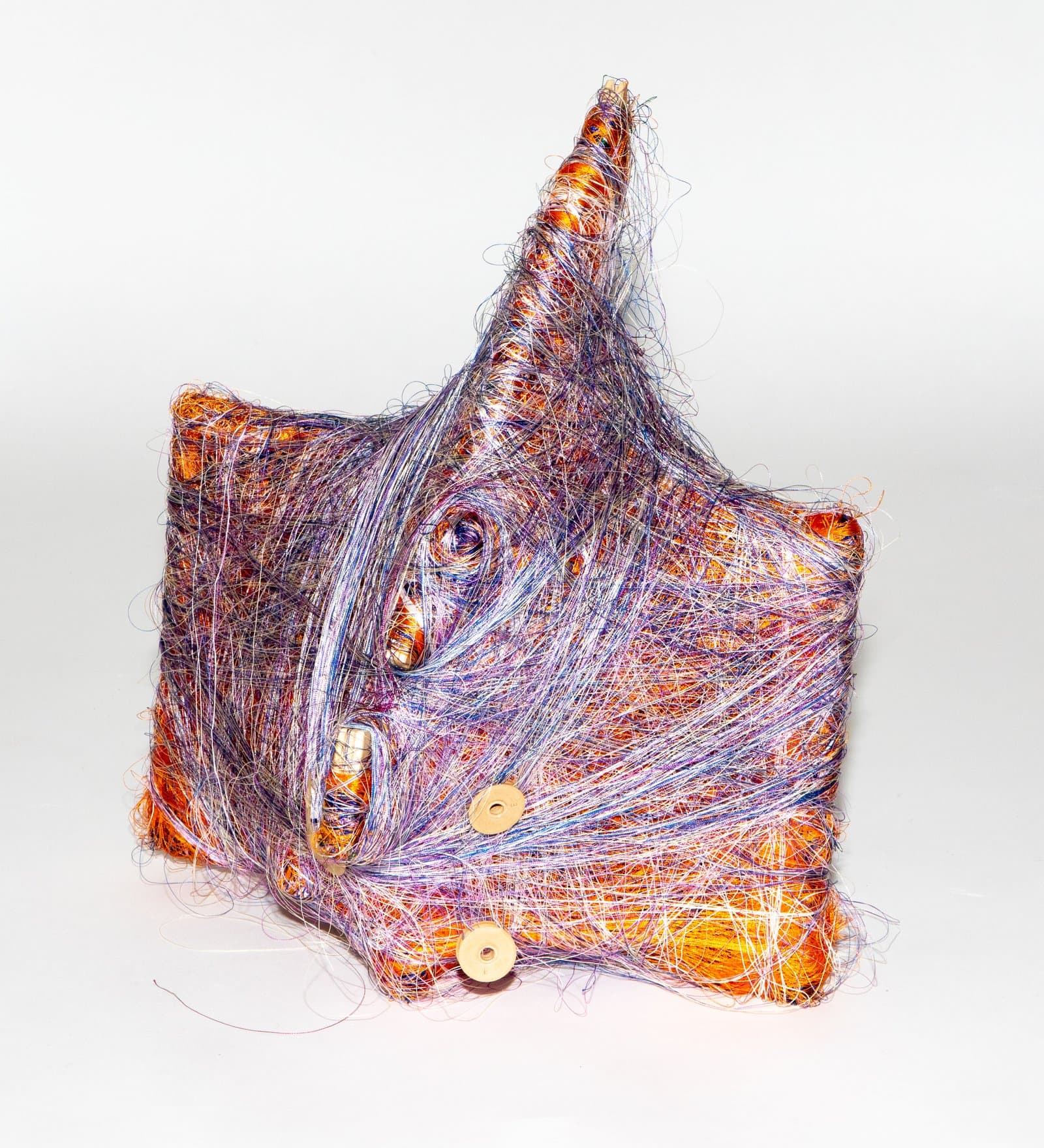Wrapped sculpture with a pointed peak, densely wound in purple and orange thread with small circular wooden discs.