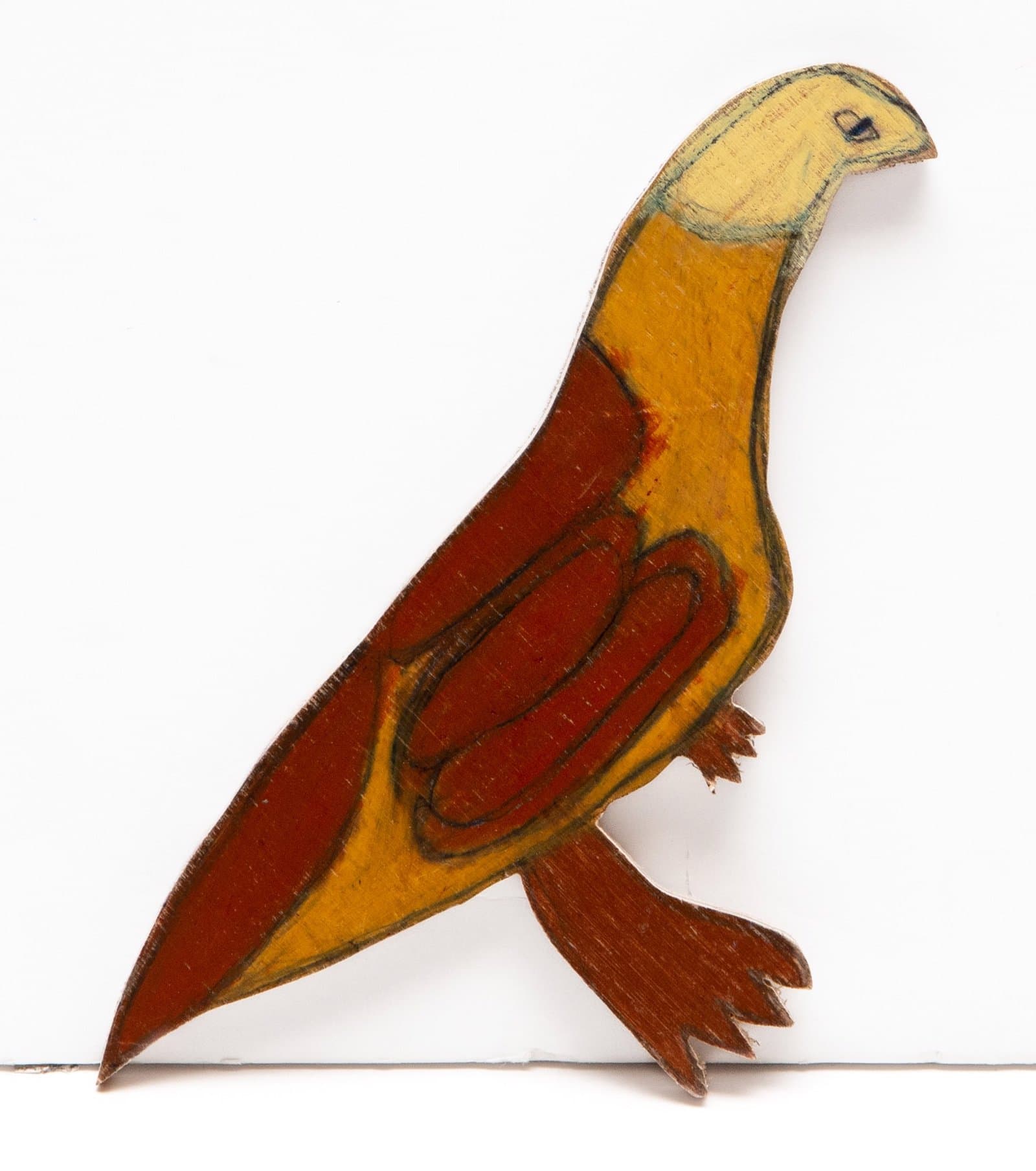 Stylized bird sculpture in Prismastix on wood with yellow head, orange and red body, positioned in profile view.