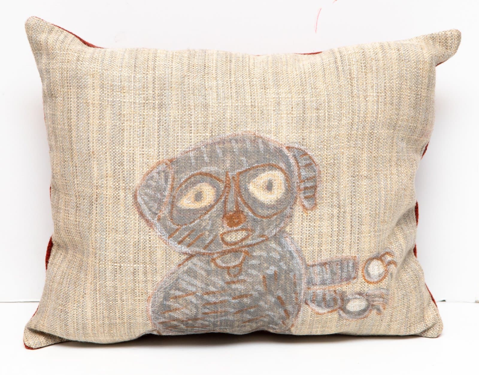 Decorative pillow in natural linen with a hand-drawn dog figure wearing glasses, rendered in gray and brown tones.