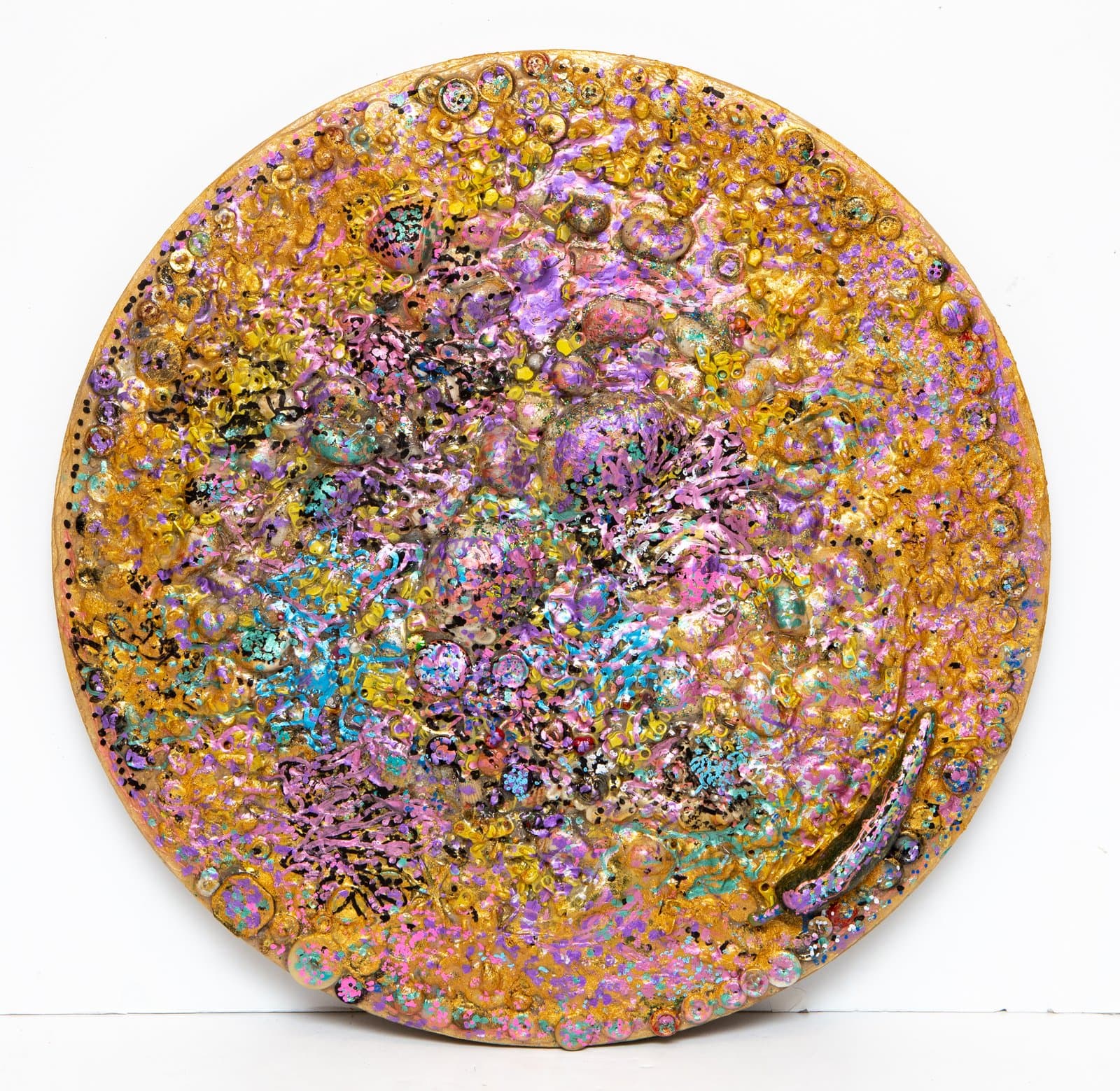 Circular mixed media work on wood panel densely textured with raised forms in gold, pink, purple, and teal.