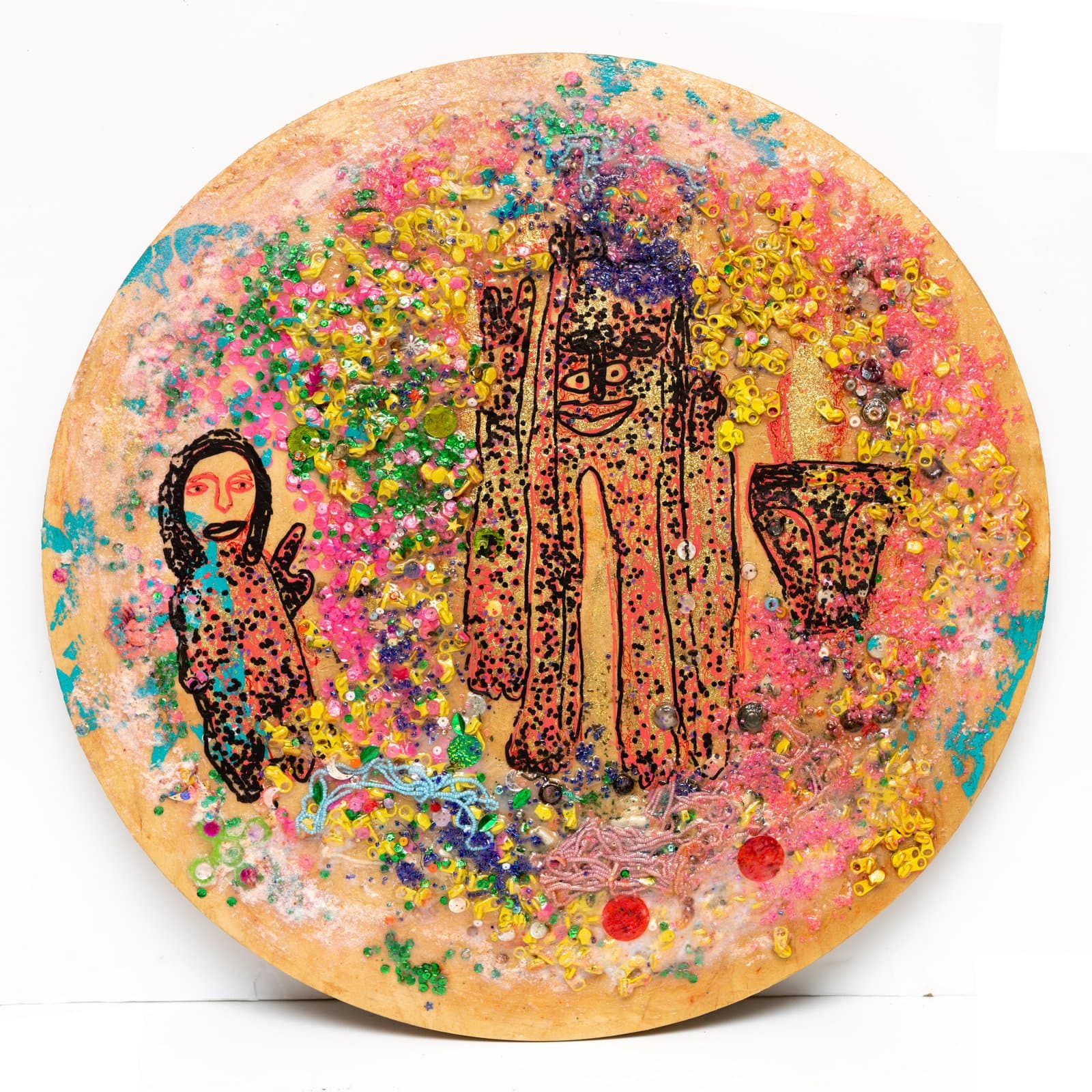Circular mixed media wood panel with two outlined human figures amid dense layers of glitter, sequins, and beads in pink, yellow, and green.