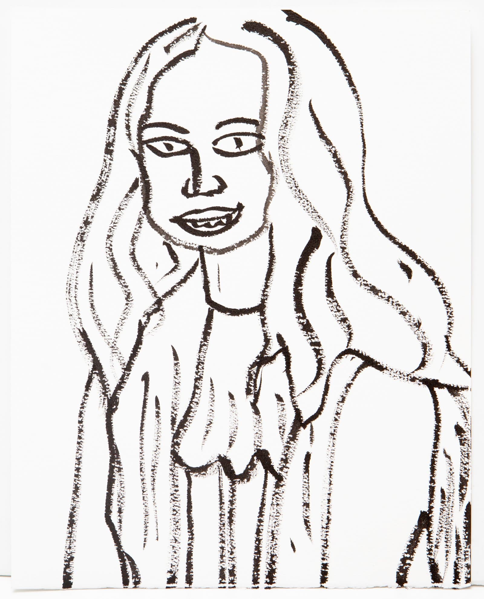 Black ink drawing on white paper of a smiling woman with long hair, rendered in bold expressive outlines.