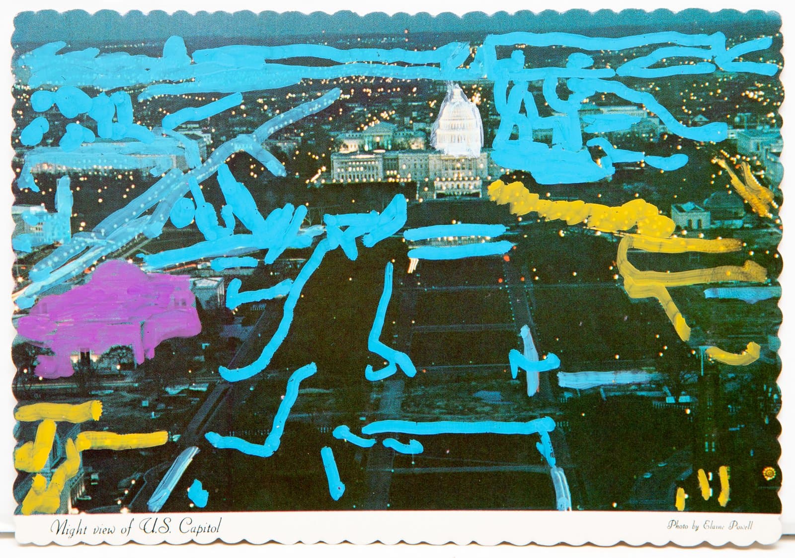 Acrylic paint in cyan, yellow, and purple applied over a found postcard of a night aerial view of the U.S. Capitol.