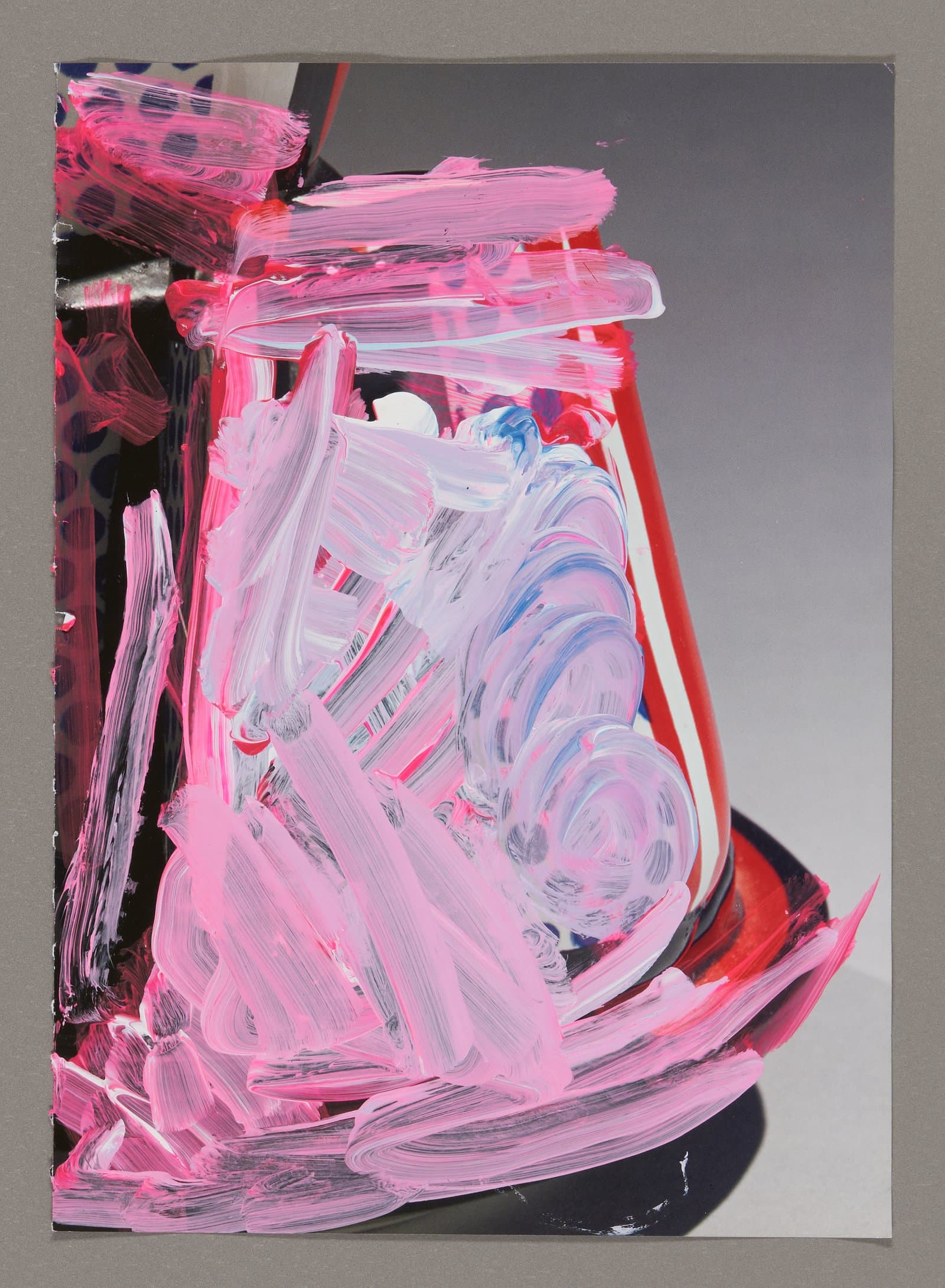 Abstract acrylic painting on magazine with dynamic pink, white, and red brushstrokes over gray background