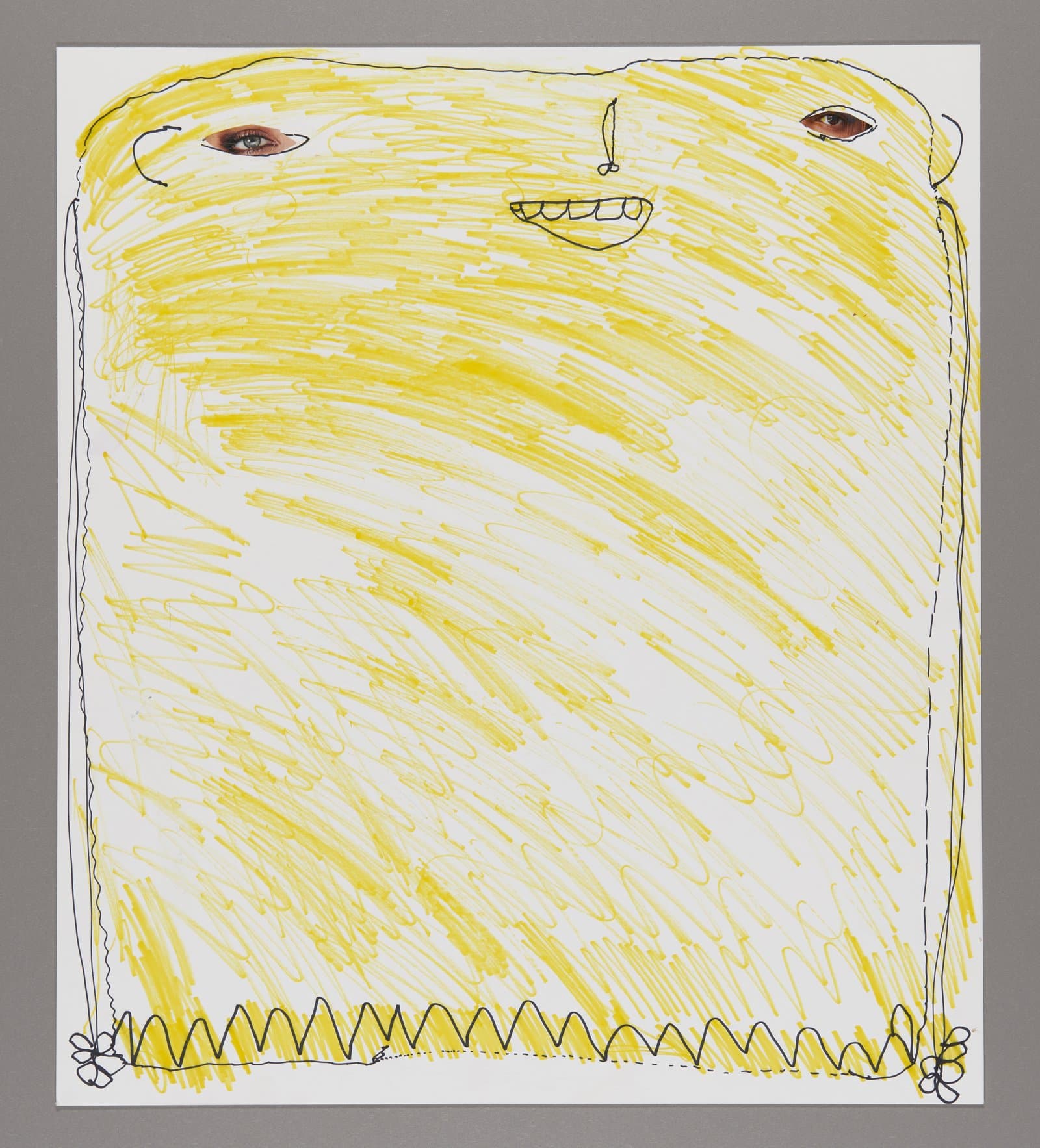 Drawing of a yellow figure with brown eyes and smiling mouth, made with marker on white paper