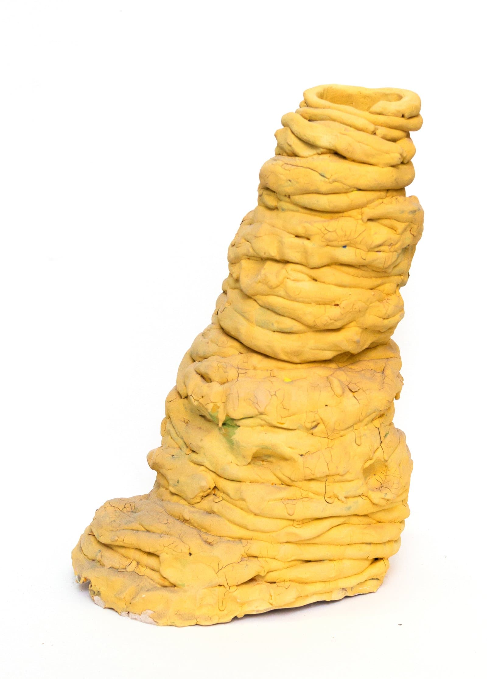 Tall yellow ceramic sculpture built from coiled and layered clay, tapering to a hollow opening at the top.