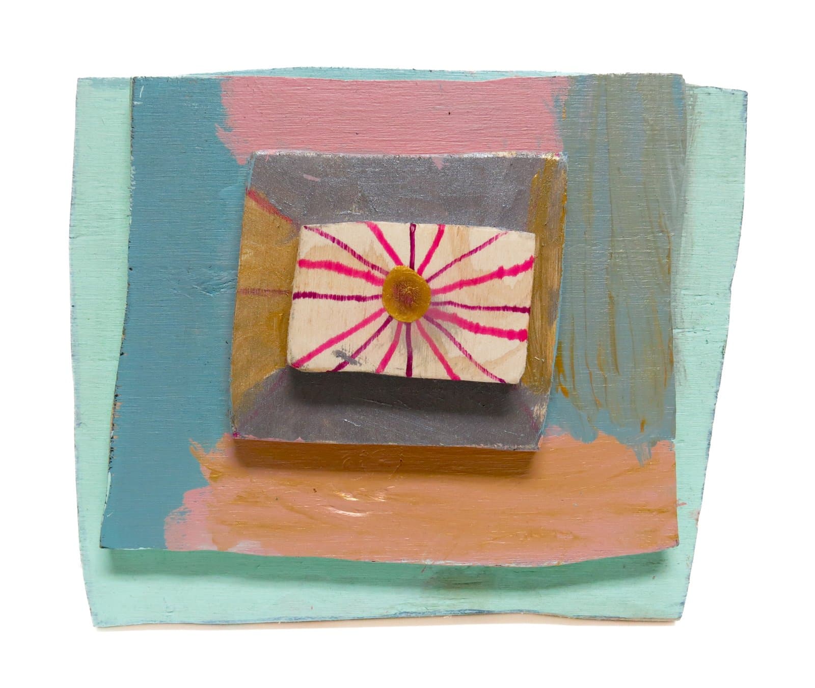 3D assemblage of painted wood panels in mint, pink, and blue, centered with a small block bearing a magenta sunburst motif.