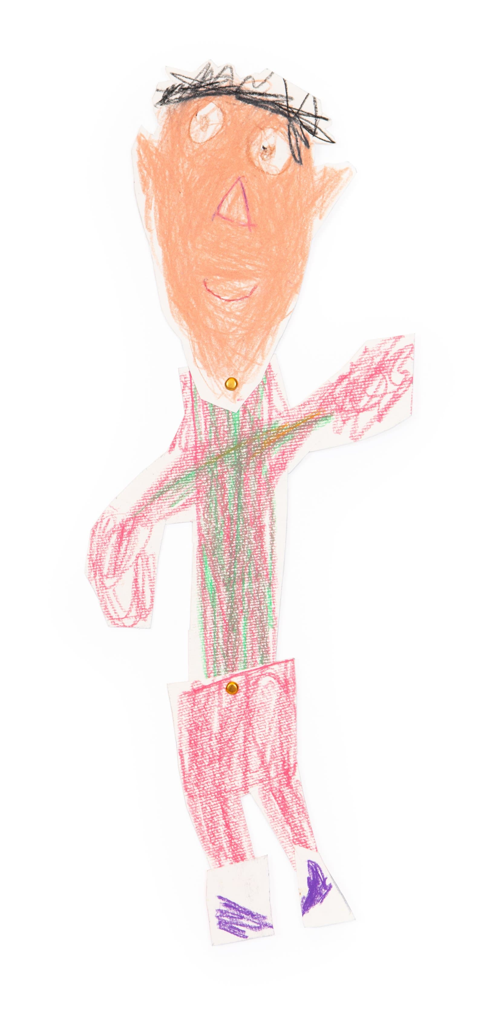 Cut-out paper puppet of a standing figure drawn in crayon with orange face, pink-red striped outfit, and purple shoes.