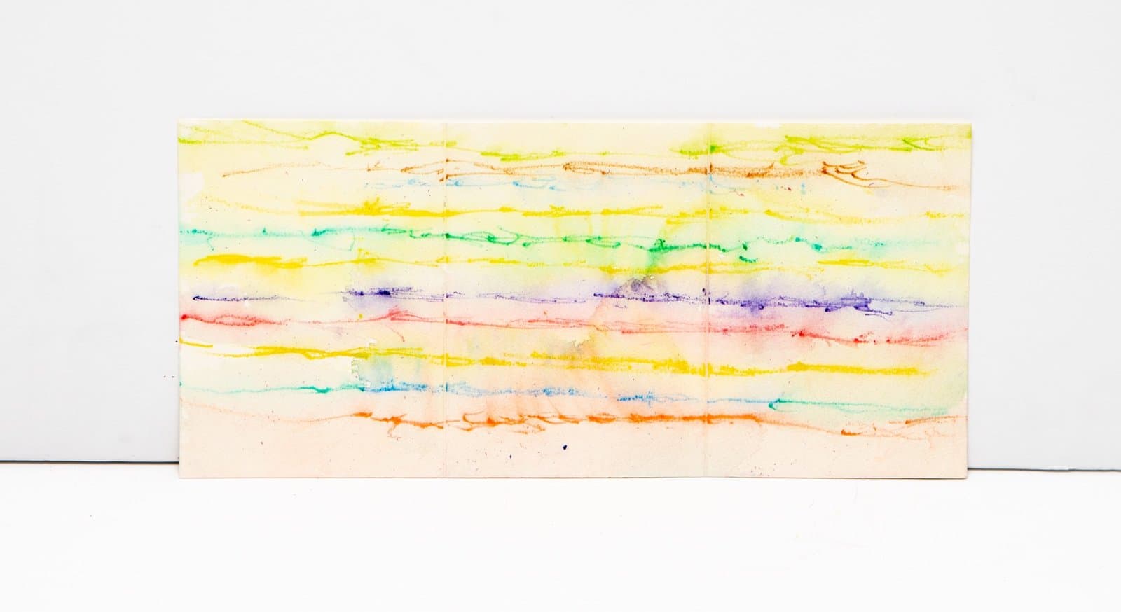 Abstract painting with horizontal bands of watercolor in yellow, green, blue, purple, red, and orange on white paper.
