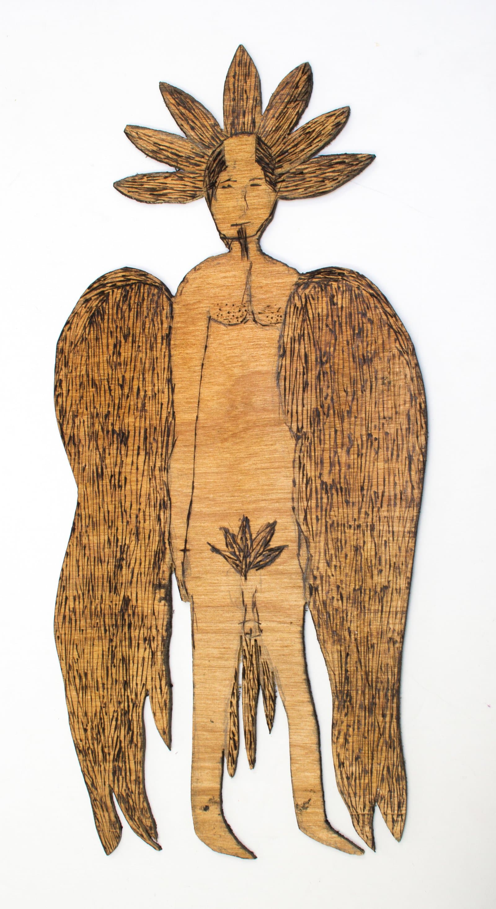 Pyrography on cut wood panel depicting a winged humanoid figure with a flower-petal crown, in warm brown tones.