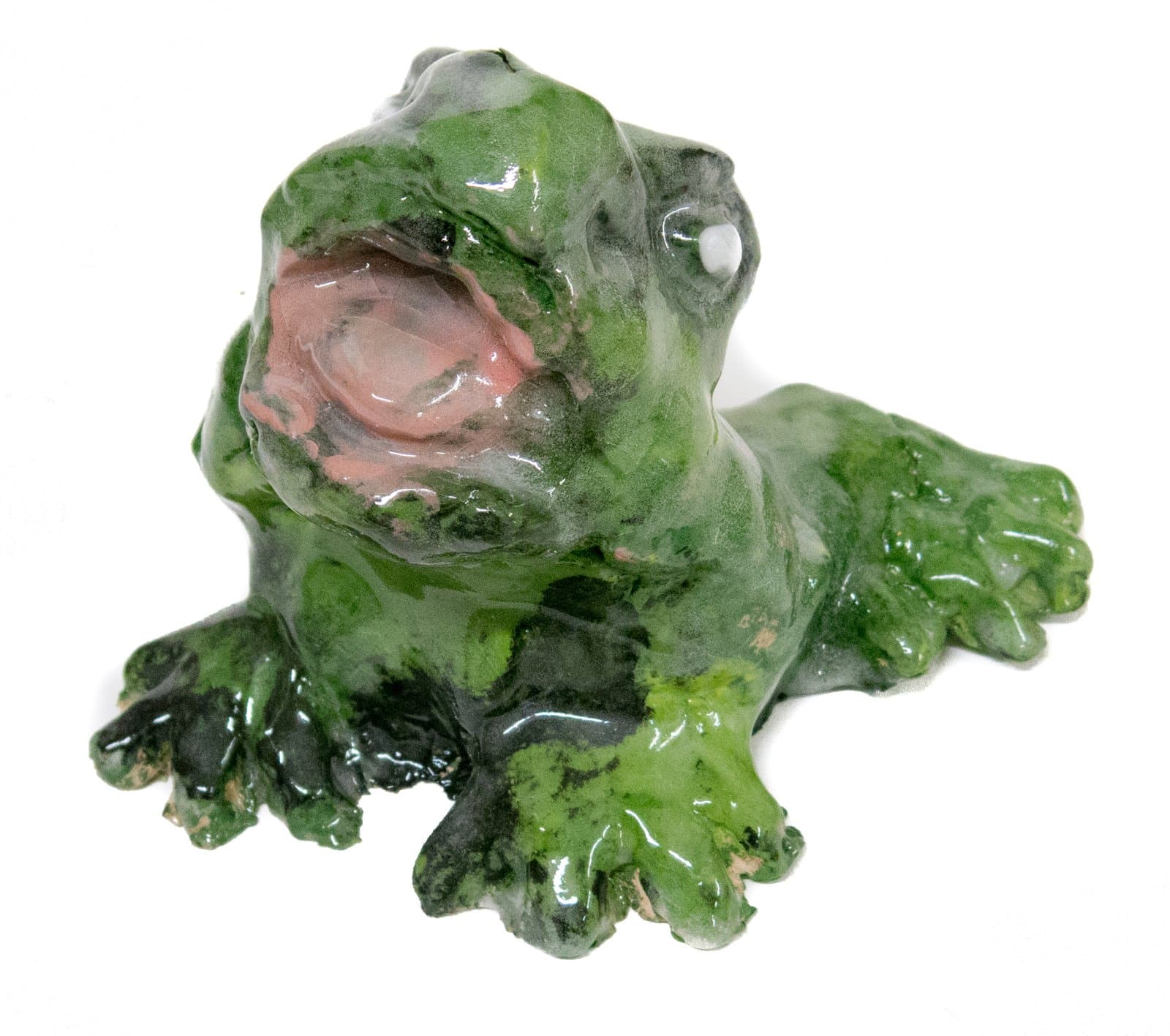 Glazed ceramic frog sculpture with open mouth, mottled green glaze, and pink interior, viewed from a slight angle.