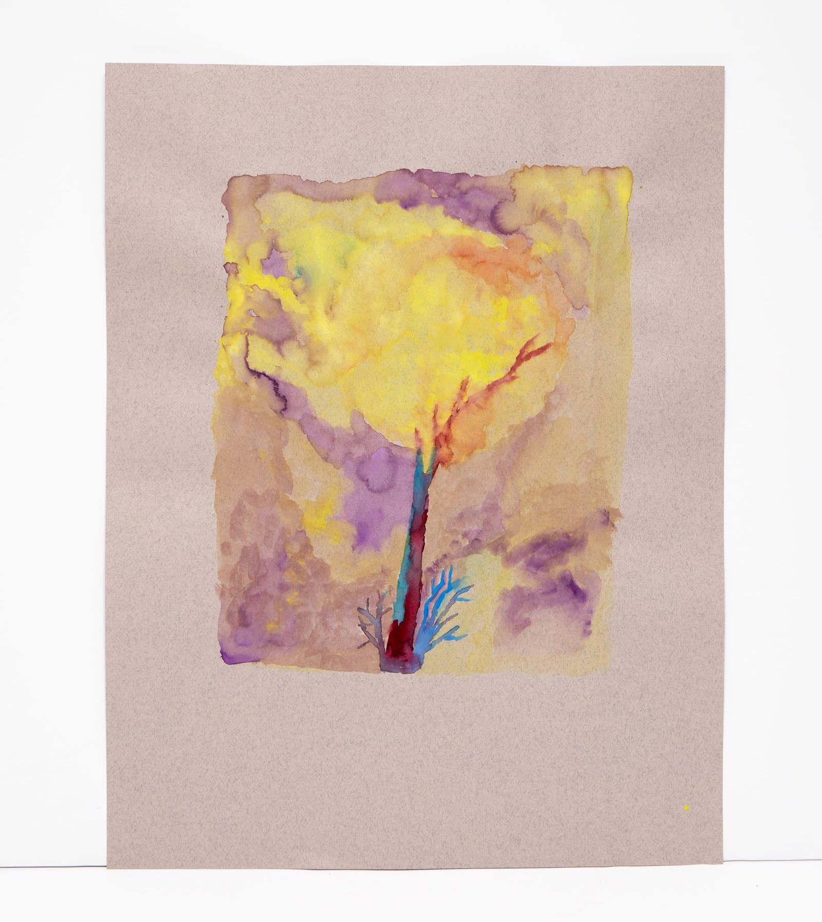 Watercolor painting of a stylized tree with yellow canopy and dark trunk on beige paper with purple atmospheric washes.