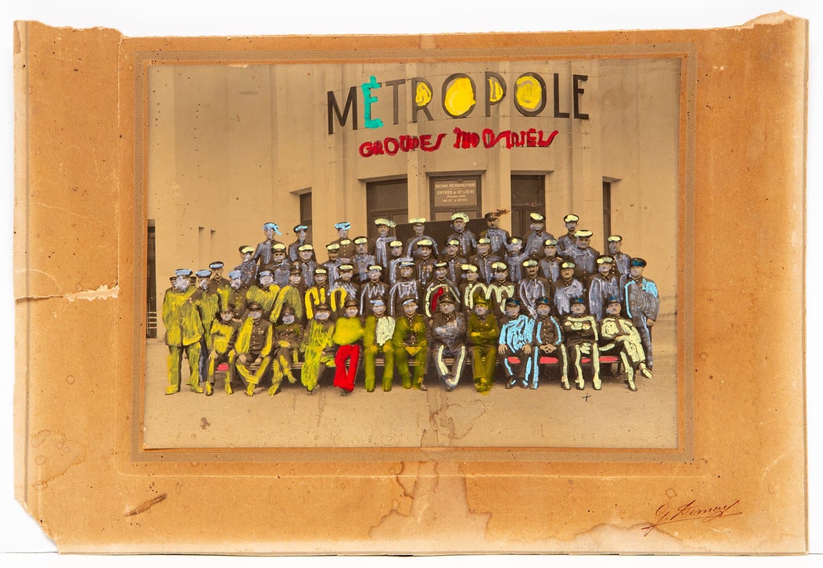 Mixed media artwork with painted text 'METROPOLE' over vintage group photograph of uniformed men on cardboard backing.