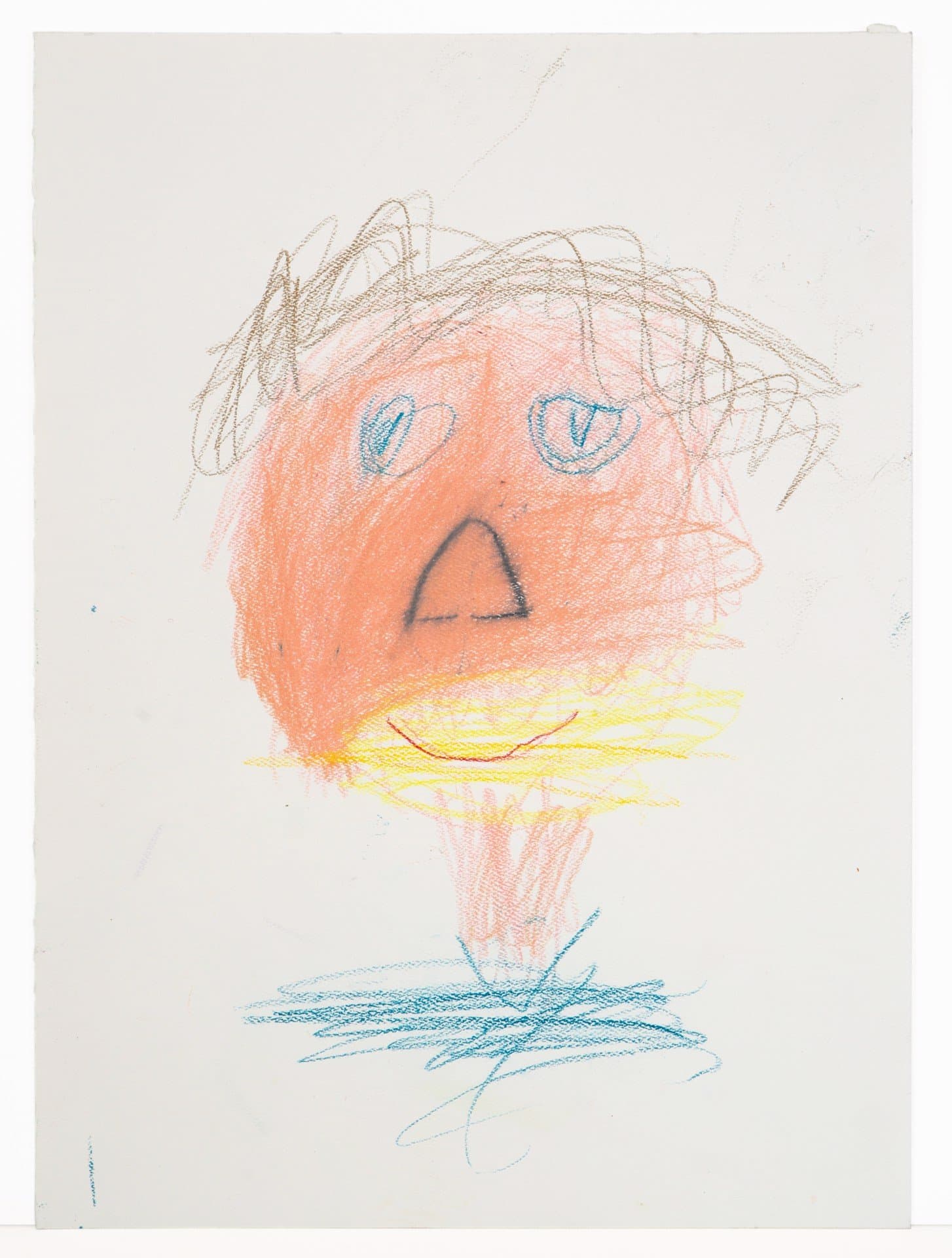 Figurative drawing in colored pencil showing a face with orange skin, blue eyes, and yellow mouth area on white paper.