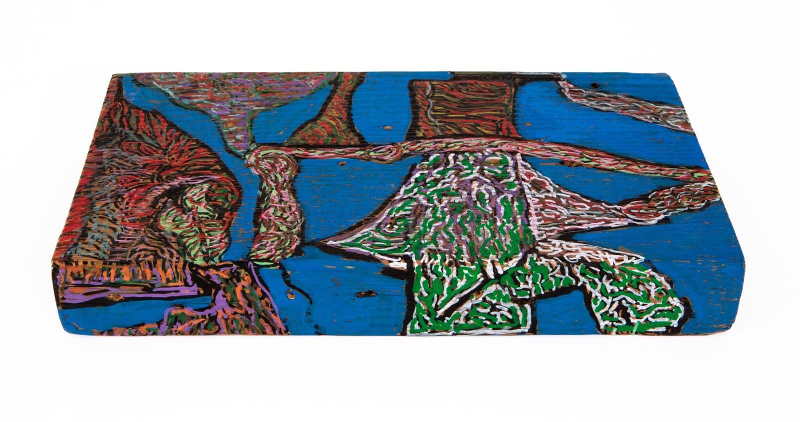 Ink drawing on wood depicting abstract figures and forms in blue, green, red, and purple on a rectangular wooden surface.