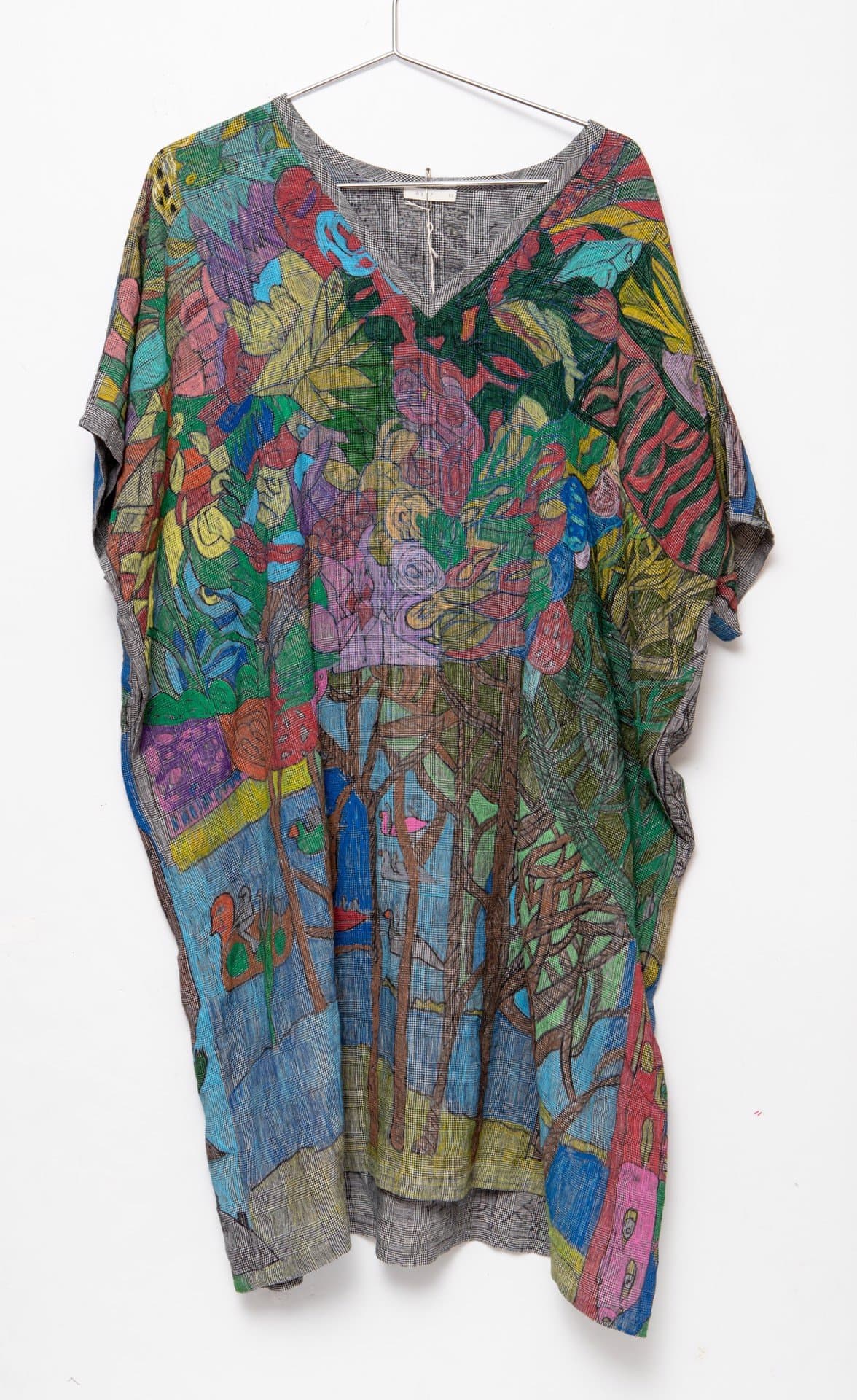 Hand-decorated kaftan-style garment with colorful marker drawings covering gray fabric, hung on wire hanger.