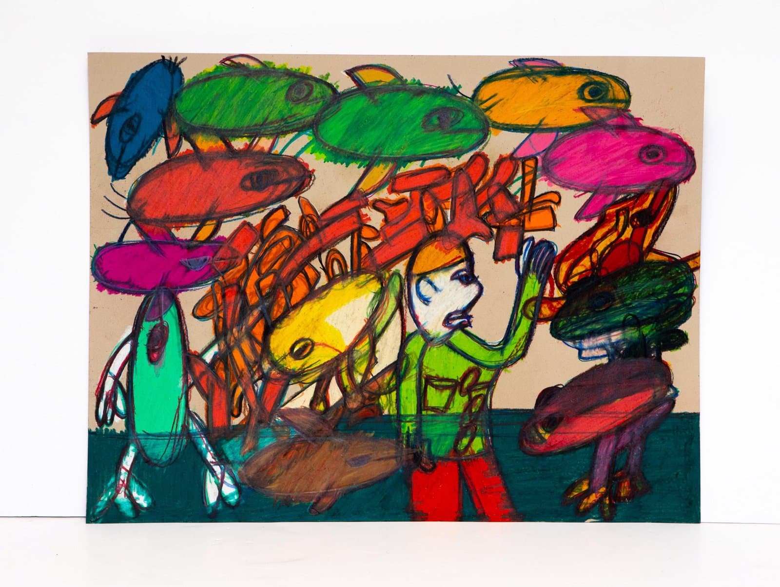 Colorful drawing in Prismastix showing multiple fish-like heads floating above a central human figure on tan and teal paper.