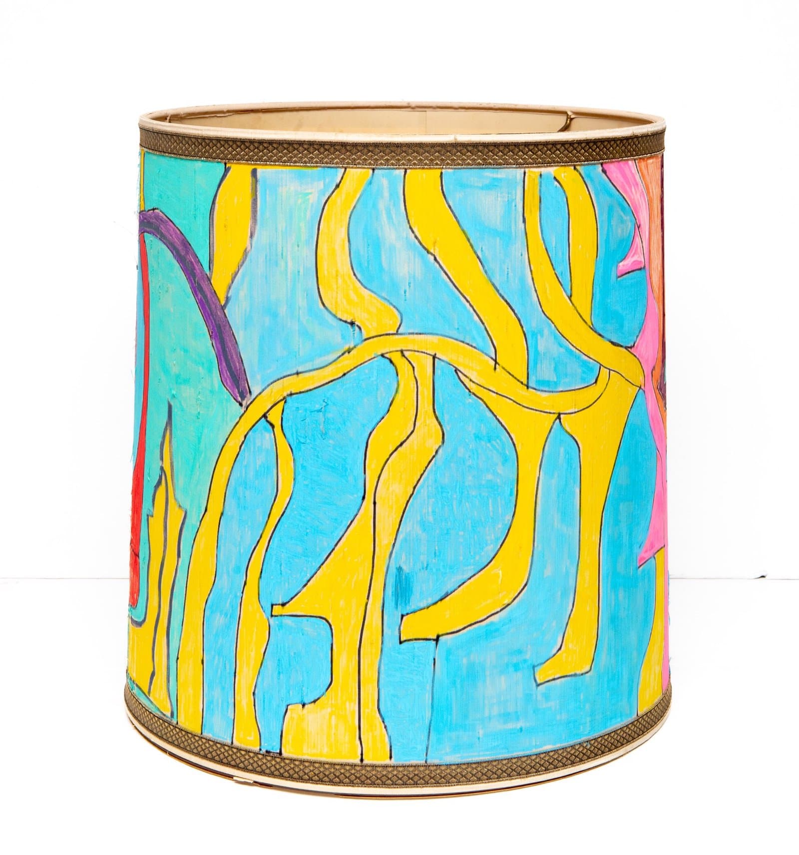 Painted lampshade with abstract yellow curved lines and forms over bright blue background with pink and purple accents.