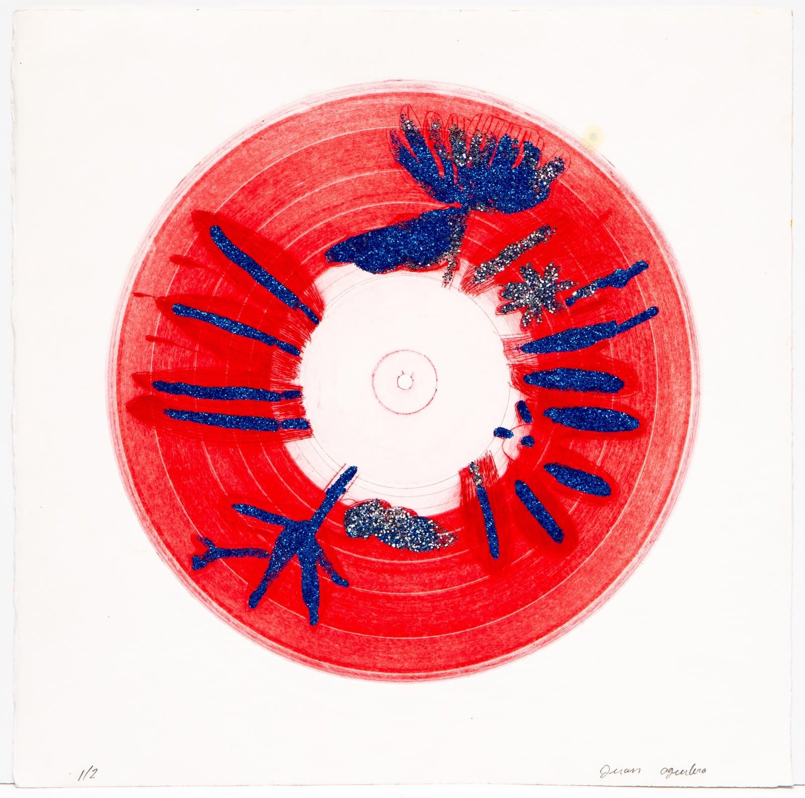 Circular relief print with red background and blue glitter elements radiating from white center on white paper.