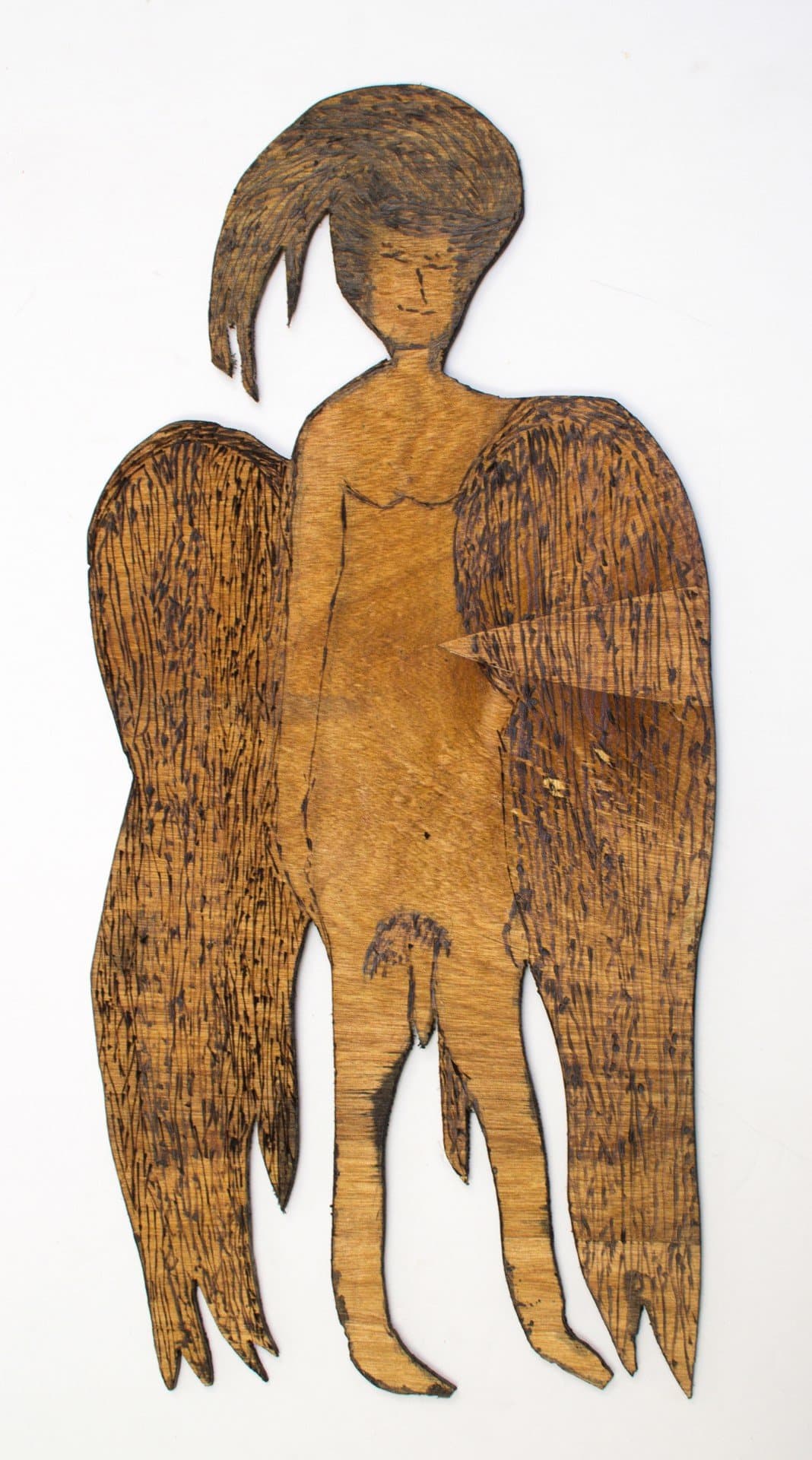 Burned wood sculpture of a winged figure with flowing hair, created through pyrography technique