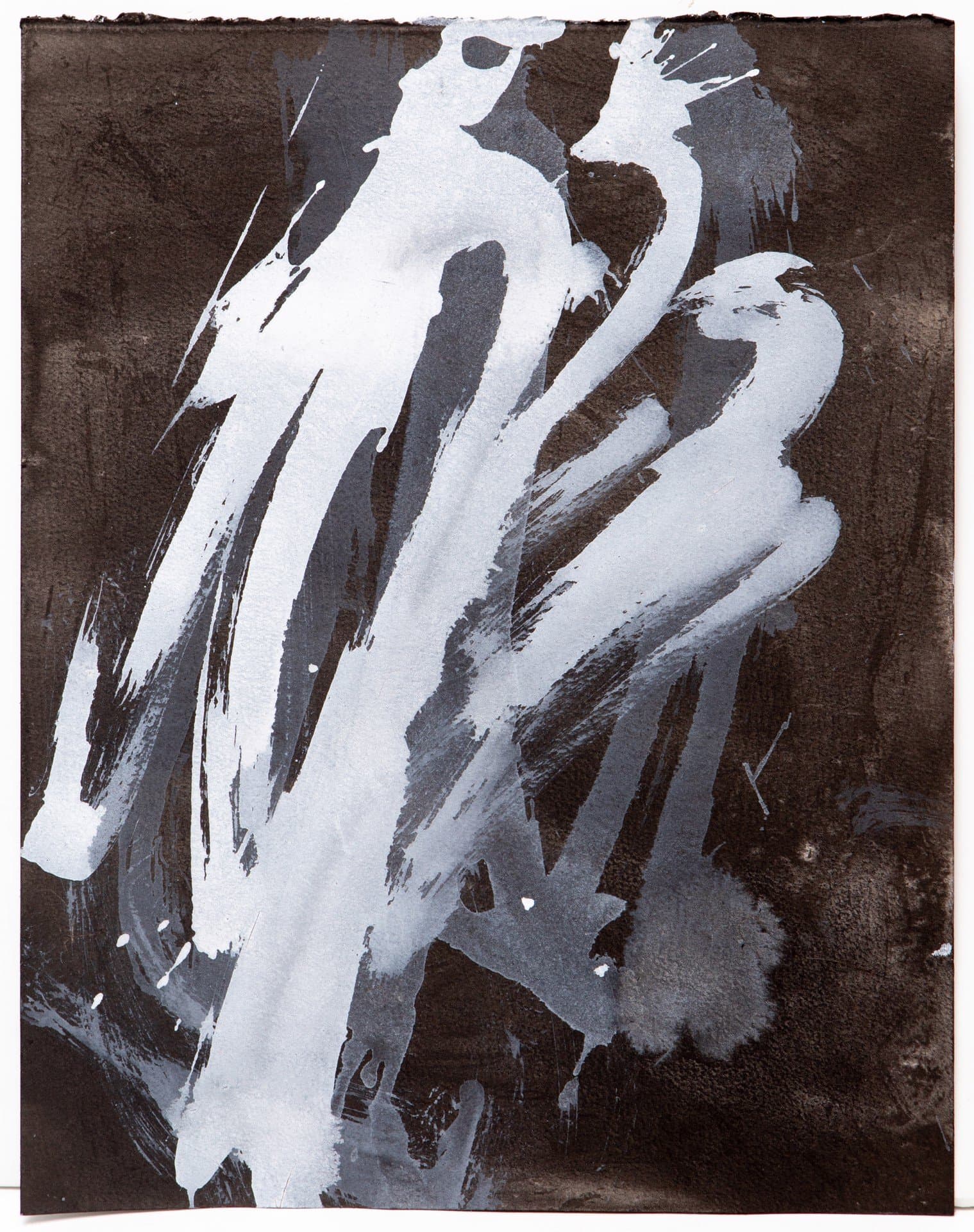 Abstract ink painting with bold white and gray brushstrokes on dark brown paper with rough edges