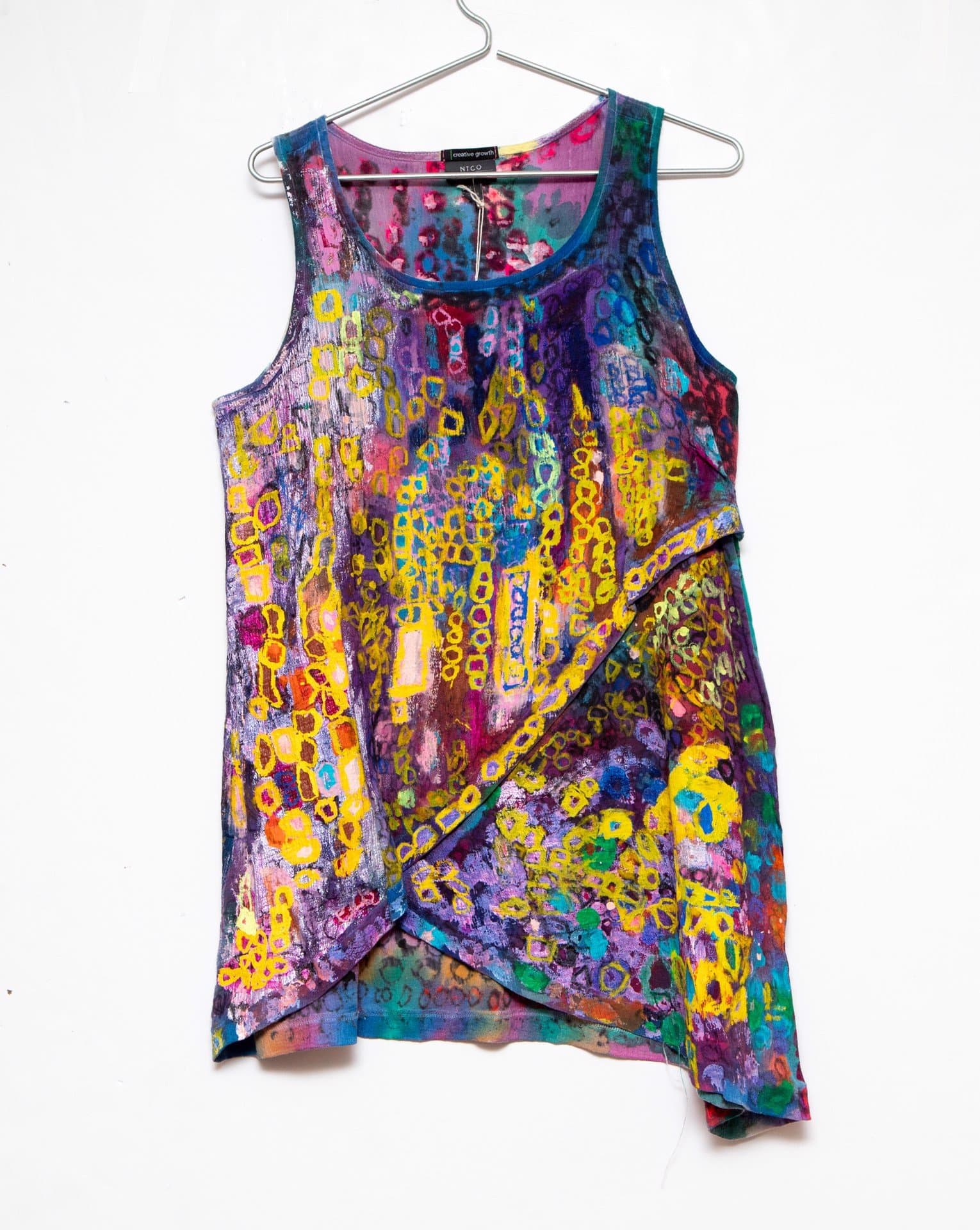 Hand-painted sleeveless tank top with vibrant abstract design in yellow, purple, blue, and pink on fabric